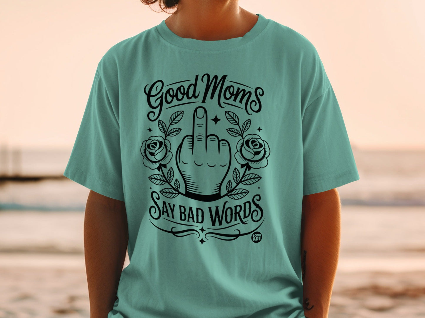 Green t-shirt with "Good Moms Say Bad Words" and a middle finger design.