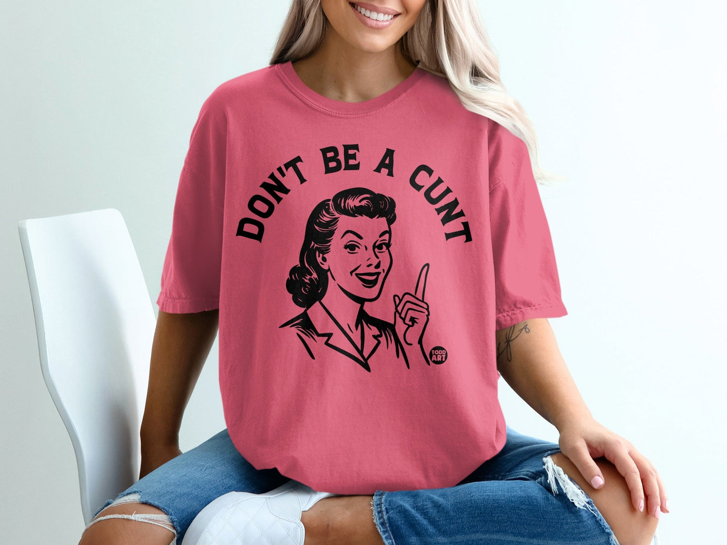 T-shirt with "DON'T BE A CUNT" and a retro woman illustration.