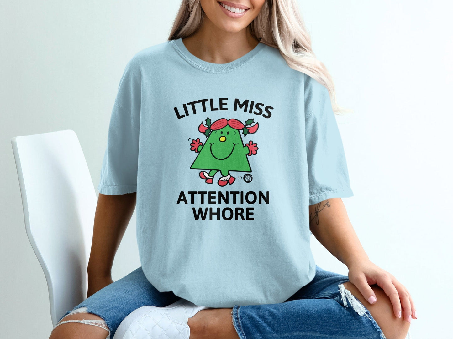 Light blue t-shirt with "Little Miss Attention Whore" text and cartoon character.