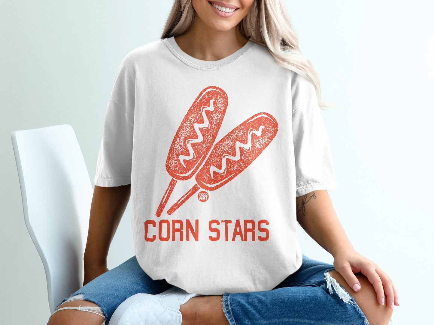 White t-shirt with two corn dog illustrations and "CORN STARS" text.
