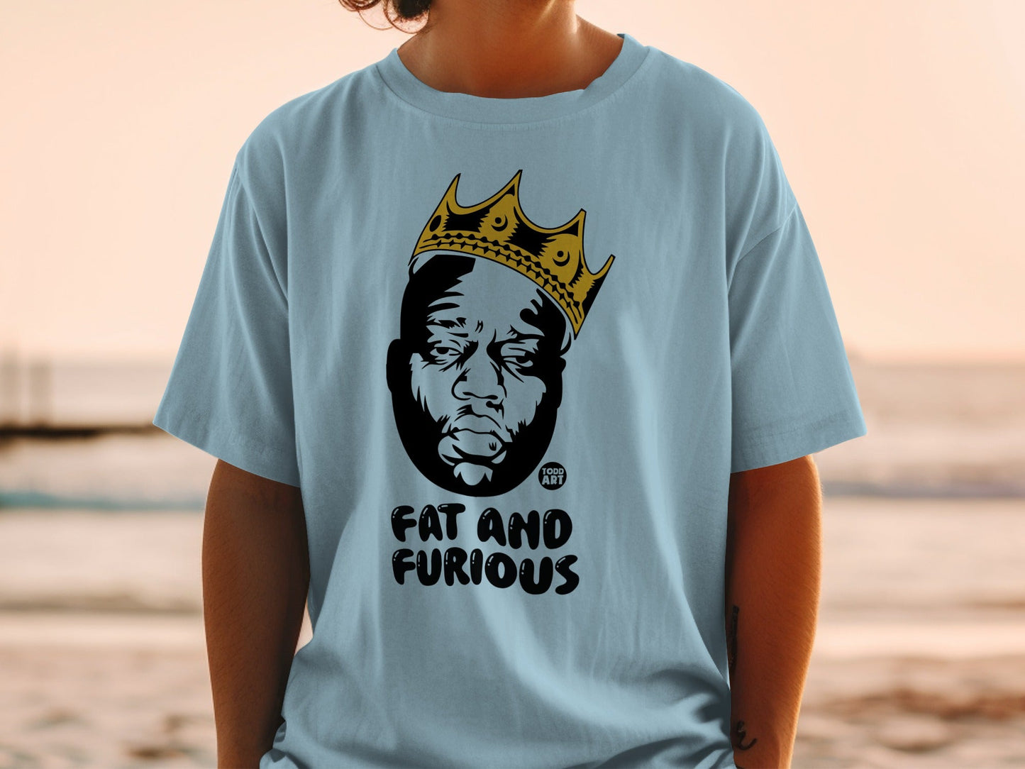 Light blue t-shirt with a black and gold crown over a portrait of The Notorious B.I.G.