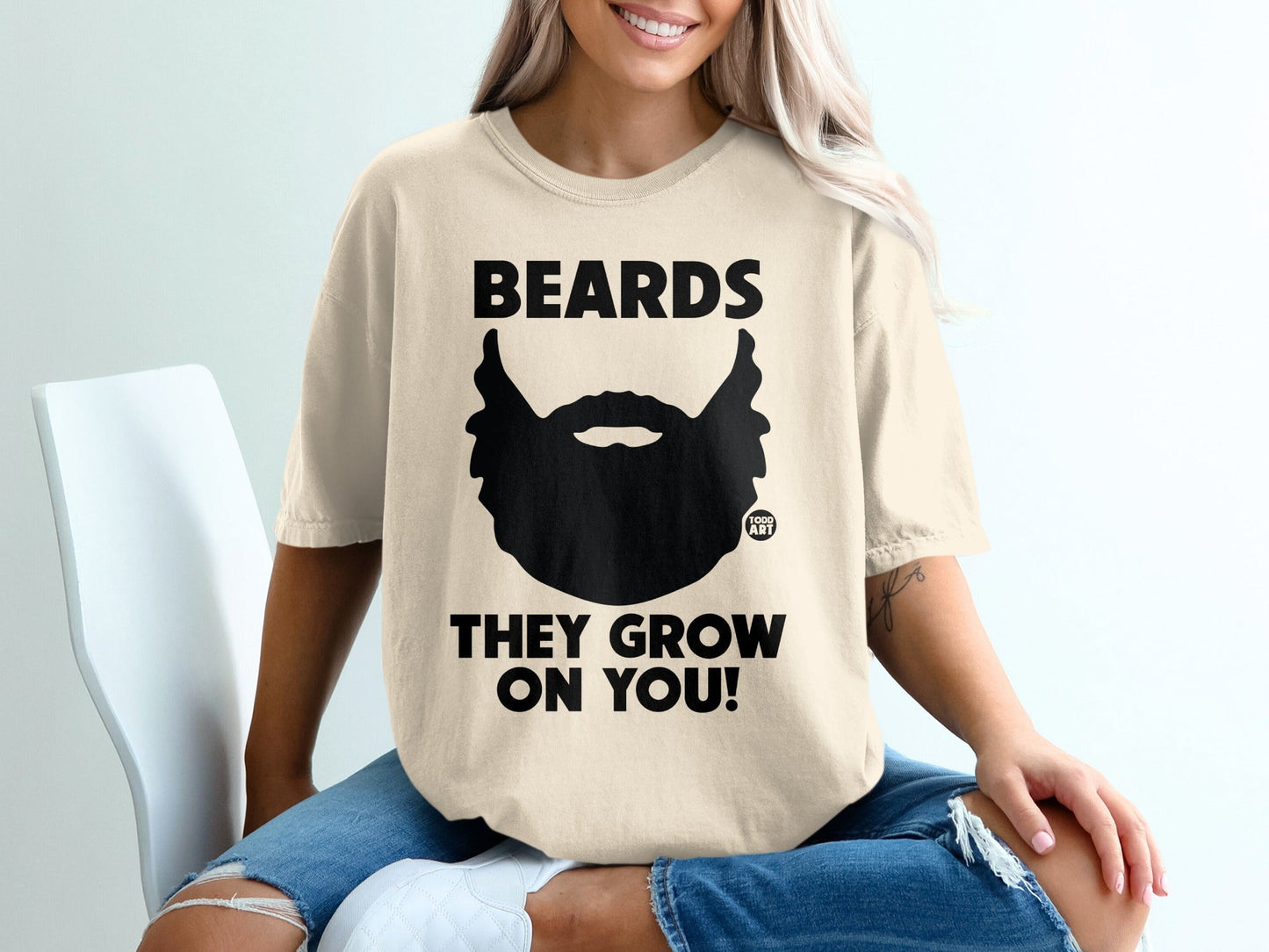 Beards they grow on you! Black beard graphic on cream t-shirt.