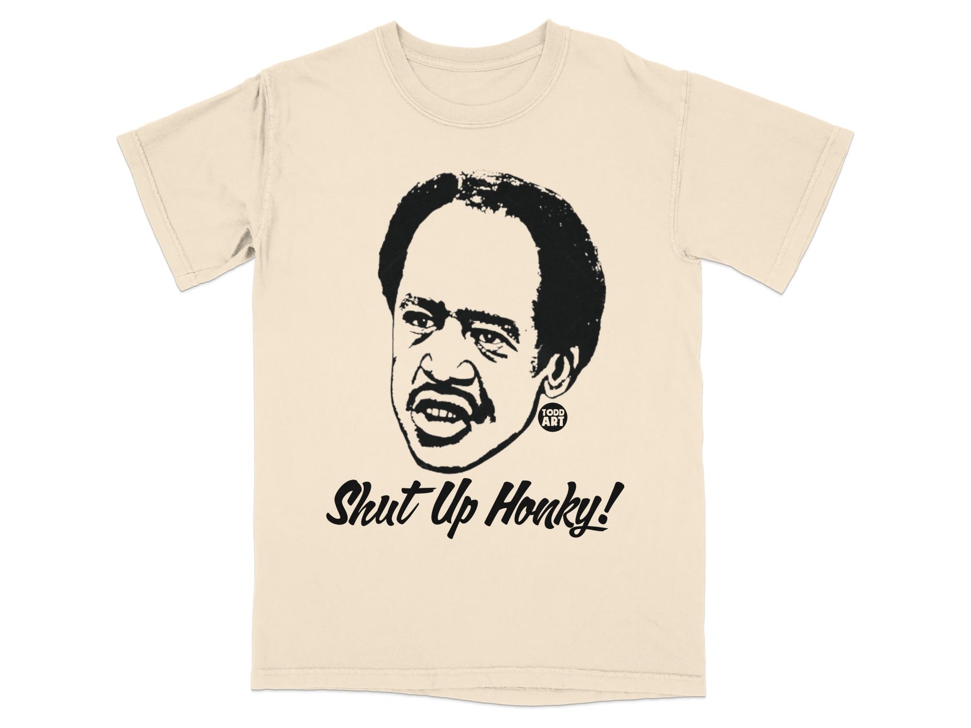 Cream t-shirt with a black graphic of a man's face and the text "Shut Up Honky!".