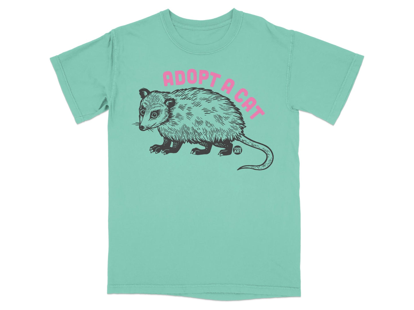 Mint t-shirt with a black line drawing of an opossum and pink text "ADOPT A CAT".