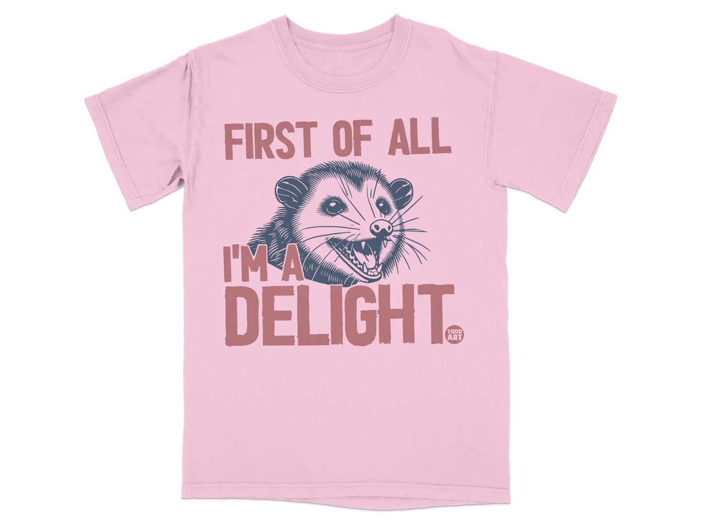 Pink t-shirt with a graphic of a possum and the text "First of all I'm a DELIGHT."