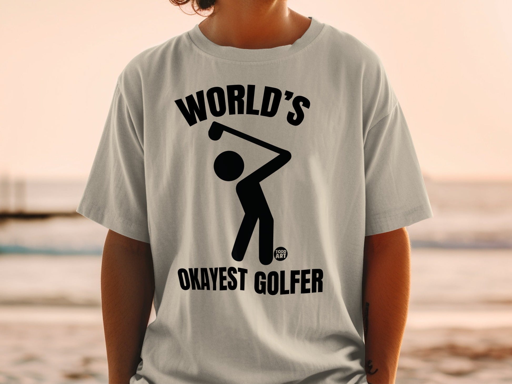 Black graphic of golfer on a white t-shirt with text: WORLD'S OKAYEST GOLFER.