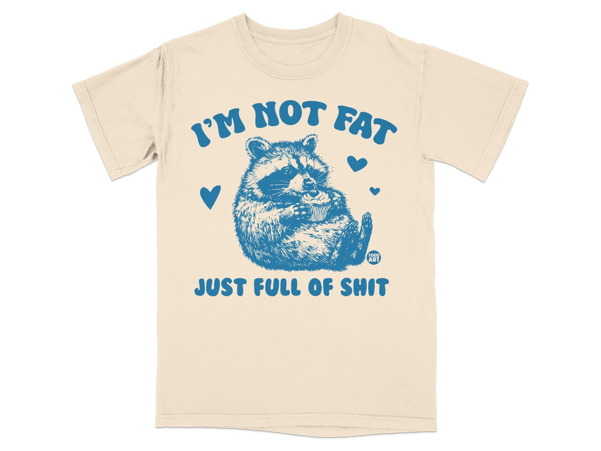 Cream t-shirt with blue raccoon graphic and text "I'm not fat, just full of shit."