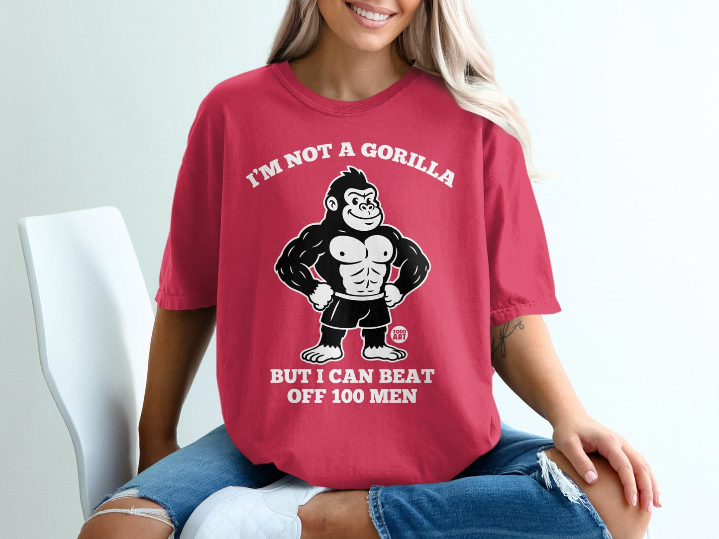 Red t-shirt with gorilla graphic and text "I'm not a gorilla but I can beat off 100 men".