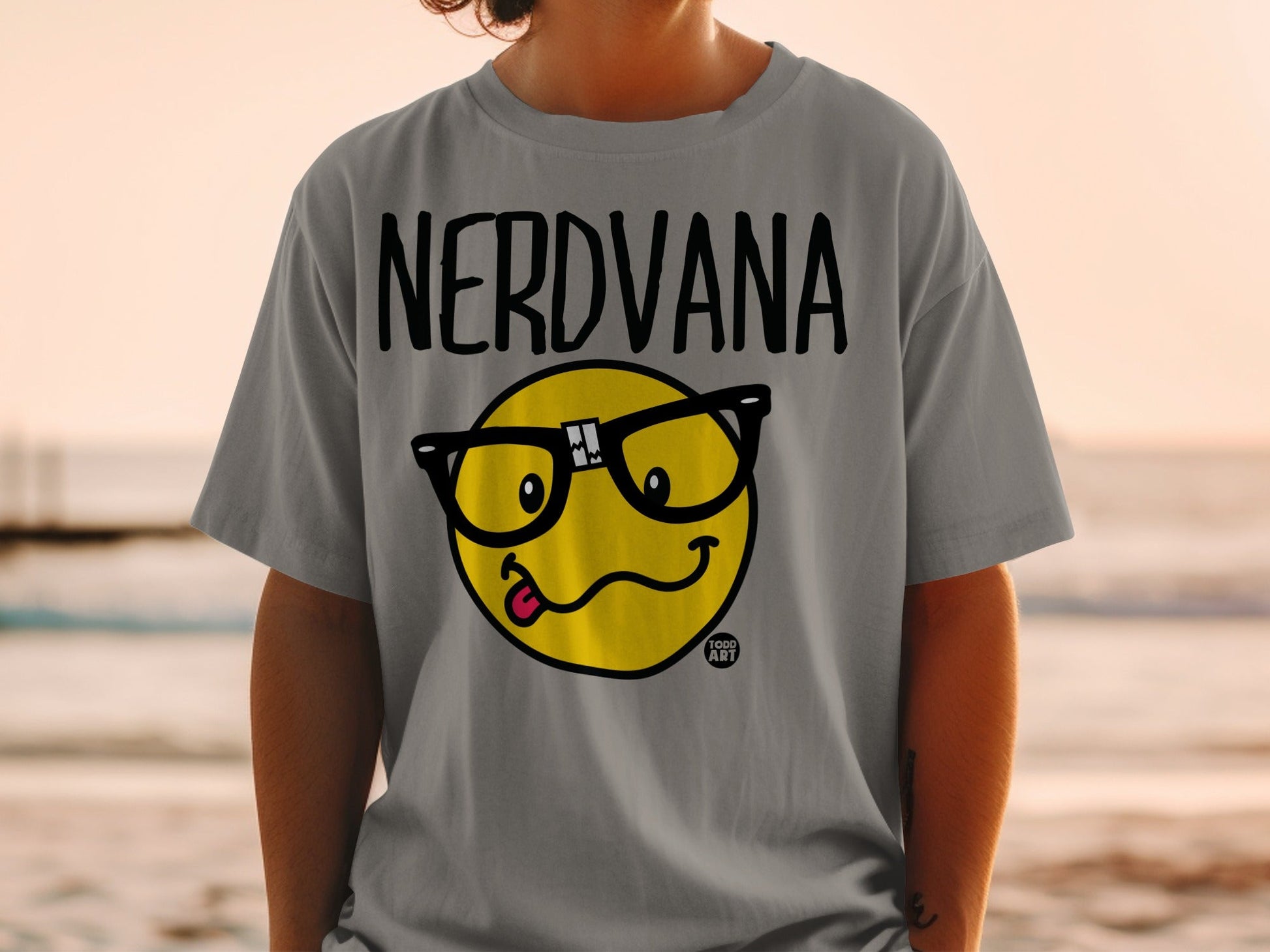 Gray t-shirt with "NERDVANA" text and a cartoon emoji with glasses.