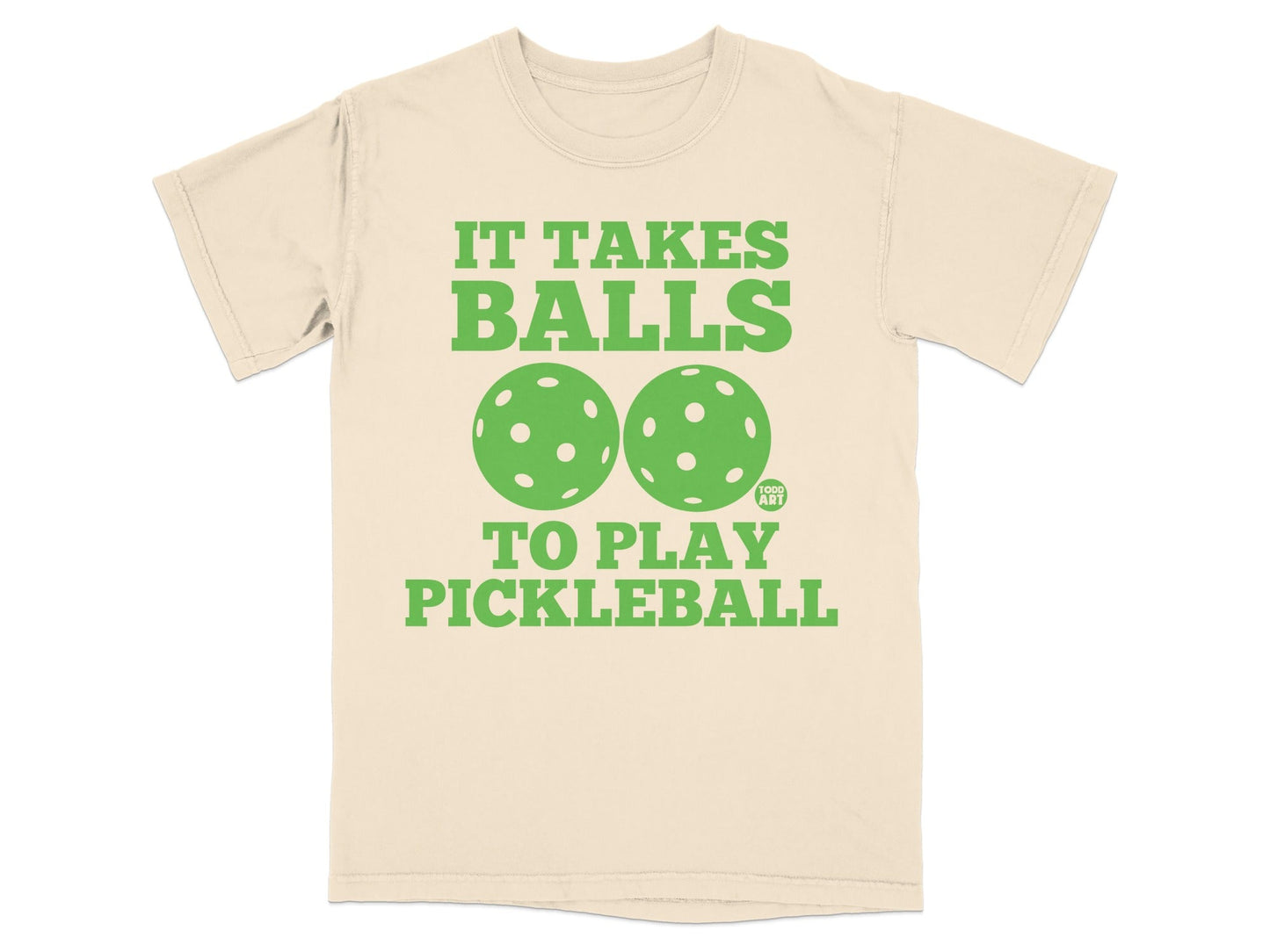 Cream t-shirt with "It Takes Balls To Play Pickleball" and pickleball graphics.