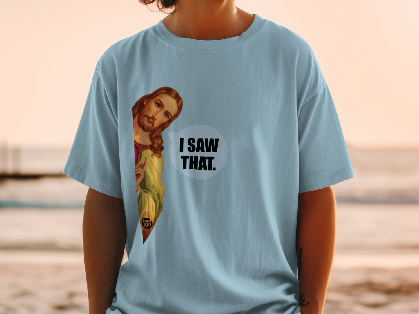 Light blue t-shirt with Jesus graphic saying "I saw that."