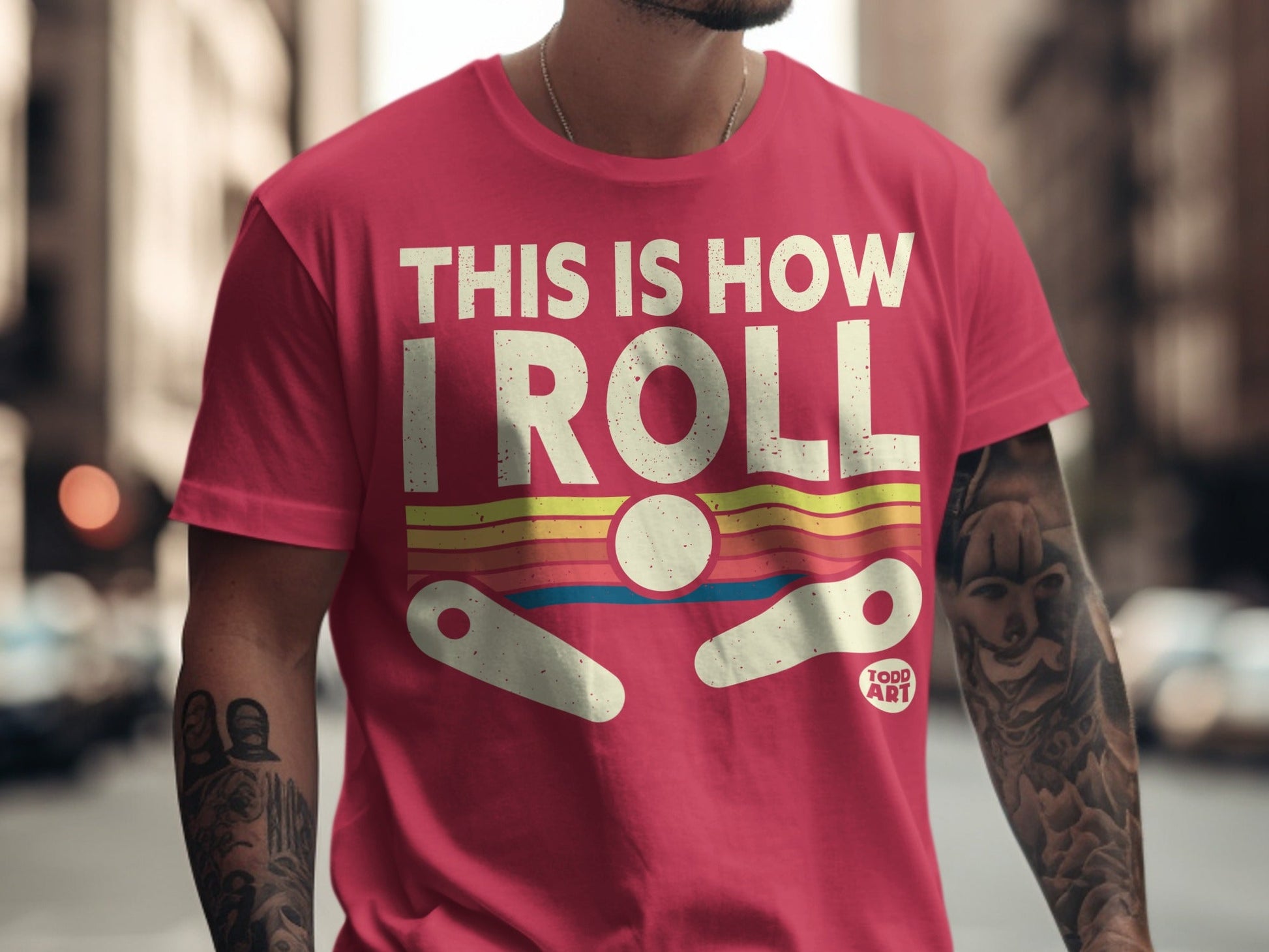 Pink t-shirt with "THIS IS HOW I ROLL" and pinball graphic.