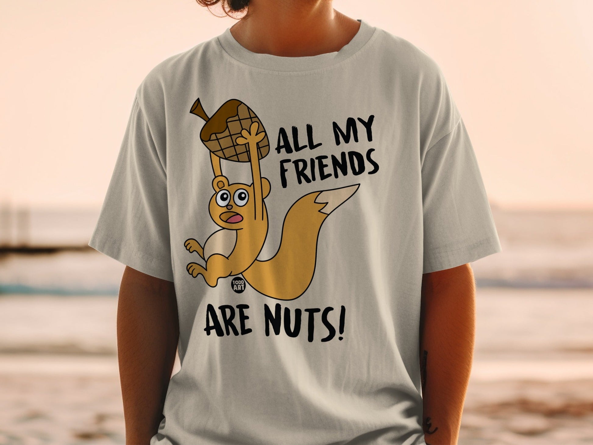 Squirrel character holding acorn with text "ALL MY FRIENDS ARE NUTS!".