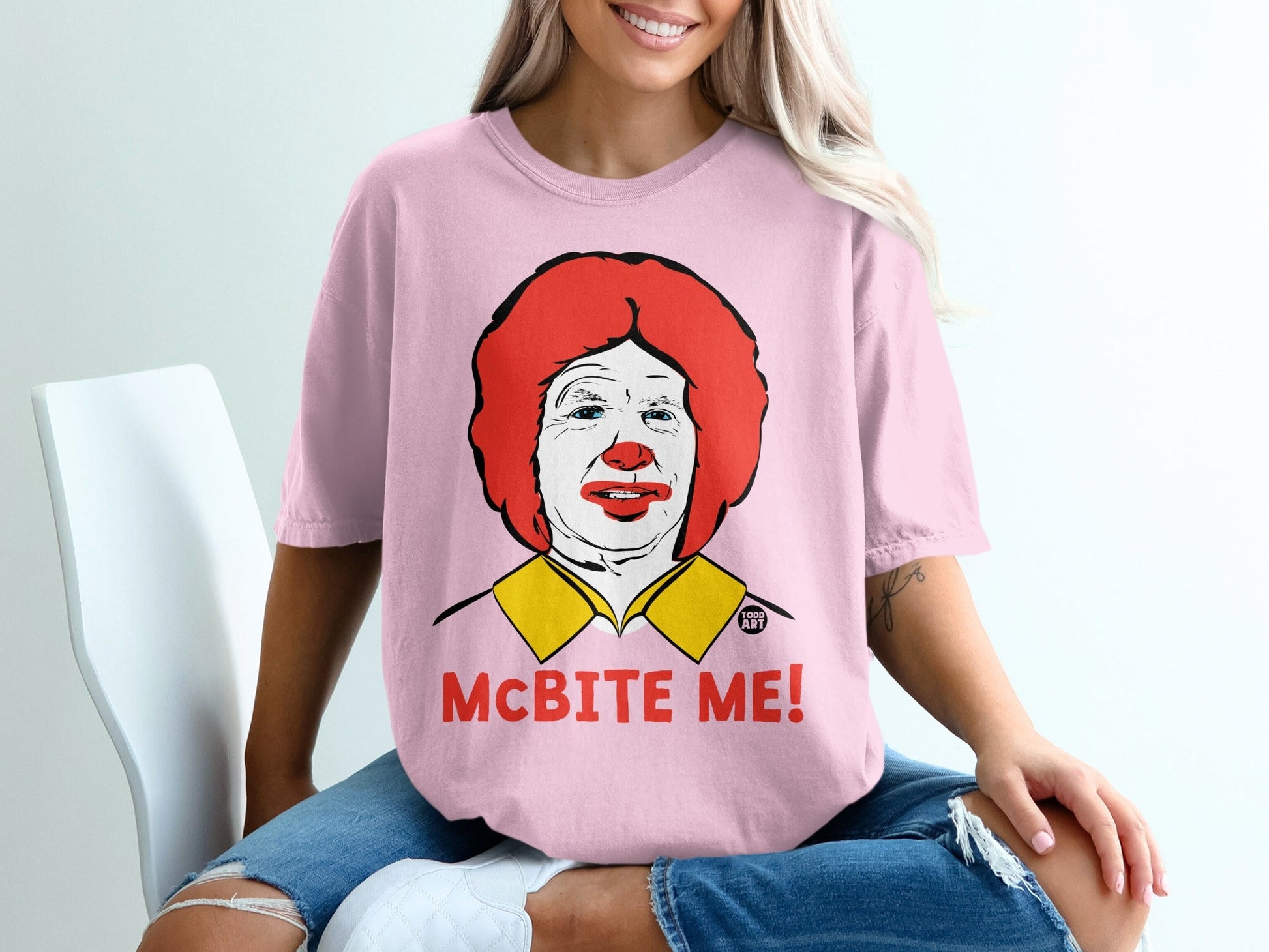 Pink t-shirt featuring a drawing of Ronald McDonald with "McBITE ME!" text.
