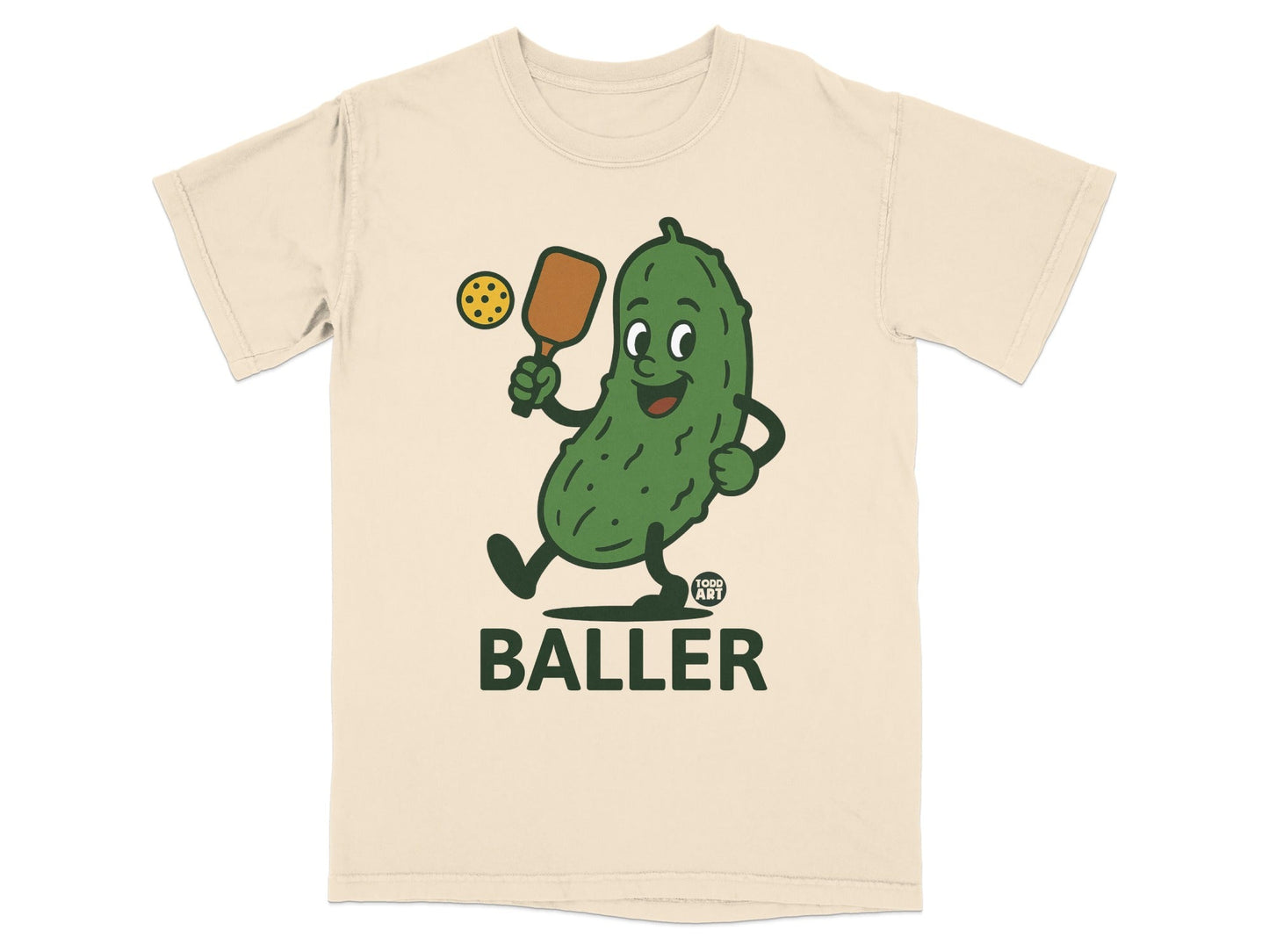 Cartoon pickle playing pickleball with "FOOD ART BALLER" text.