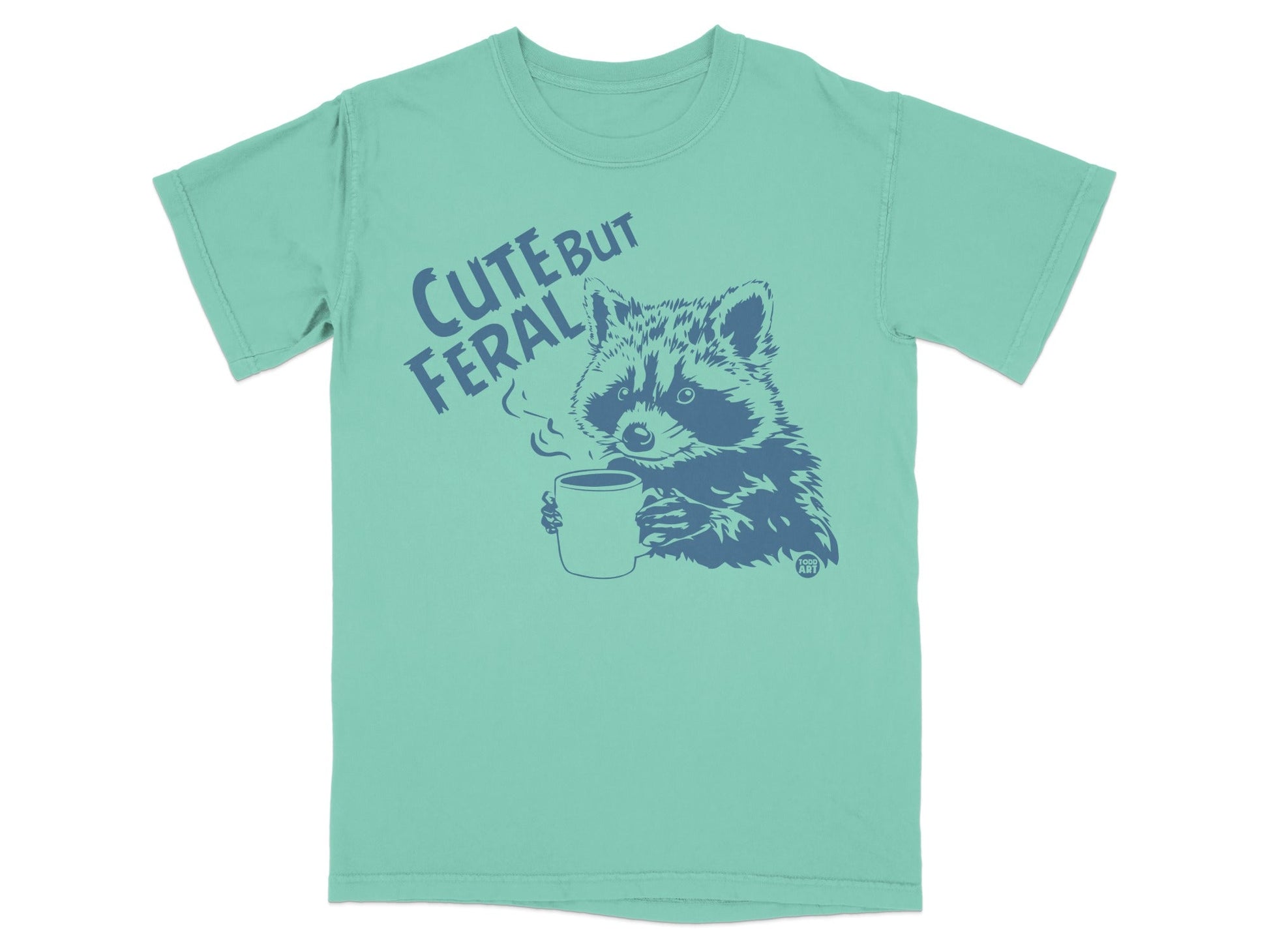 T-shirt with raccoon drinking coffee, text "CUTE BUT FERAL".