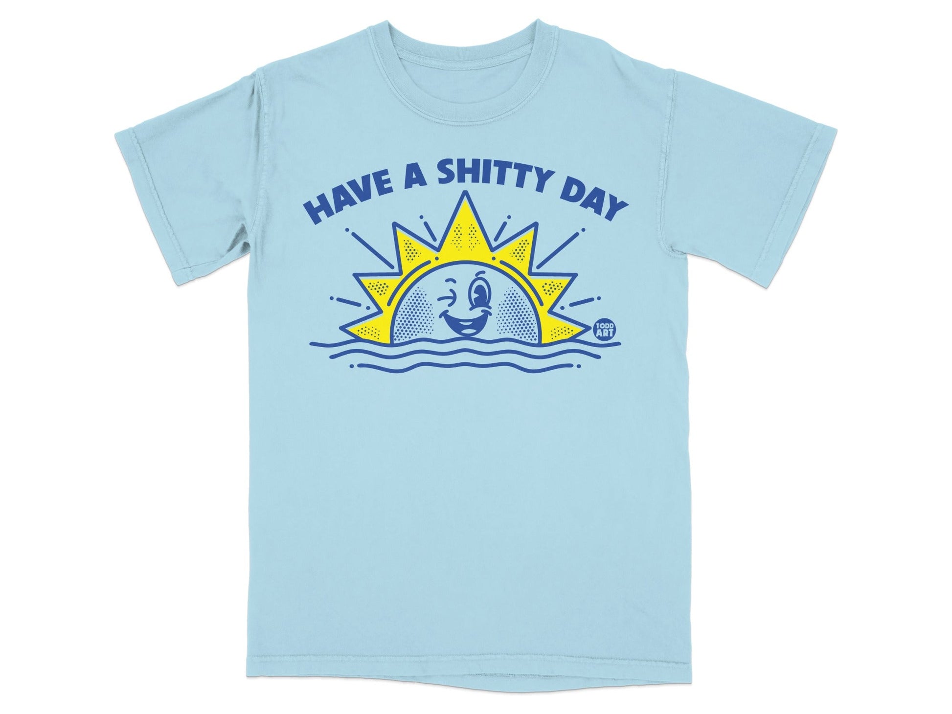 Light blue t-shirt with cartoon sun winking above wavy lines and text "HAVE A SHITTY DAY".