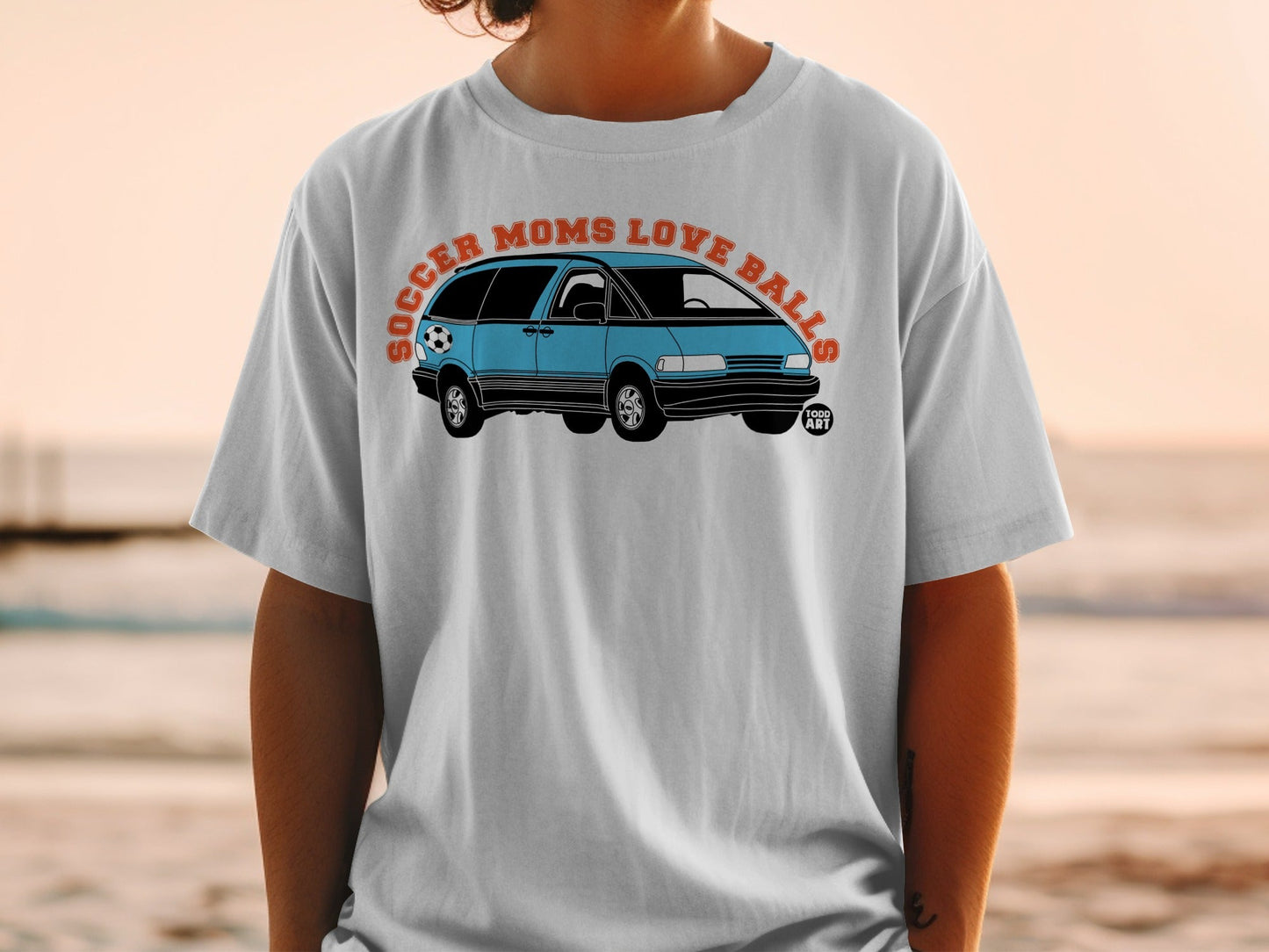 Light blue minivan with a soccer ball, text "Soccer Moms Love Balls".