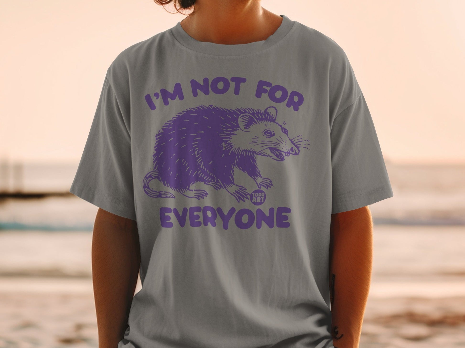 Gray t-shirt with purple possum graphic and "I'M NOT FOR EVERYONE" text.