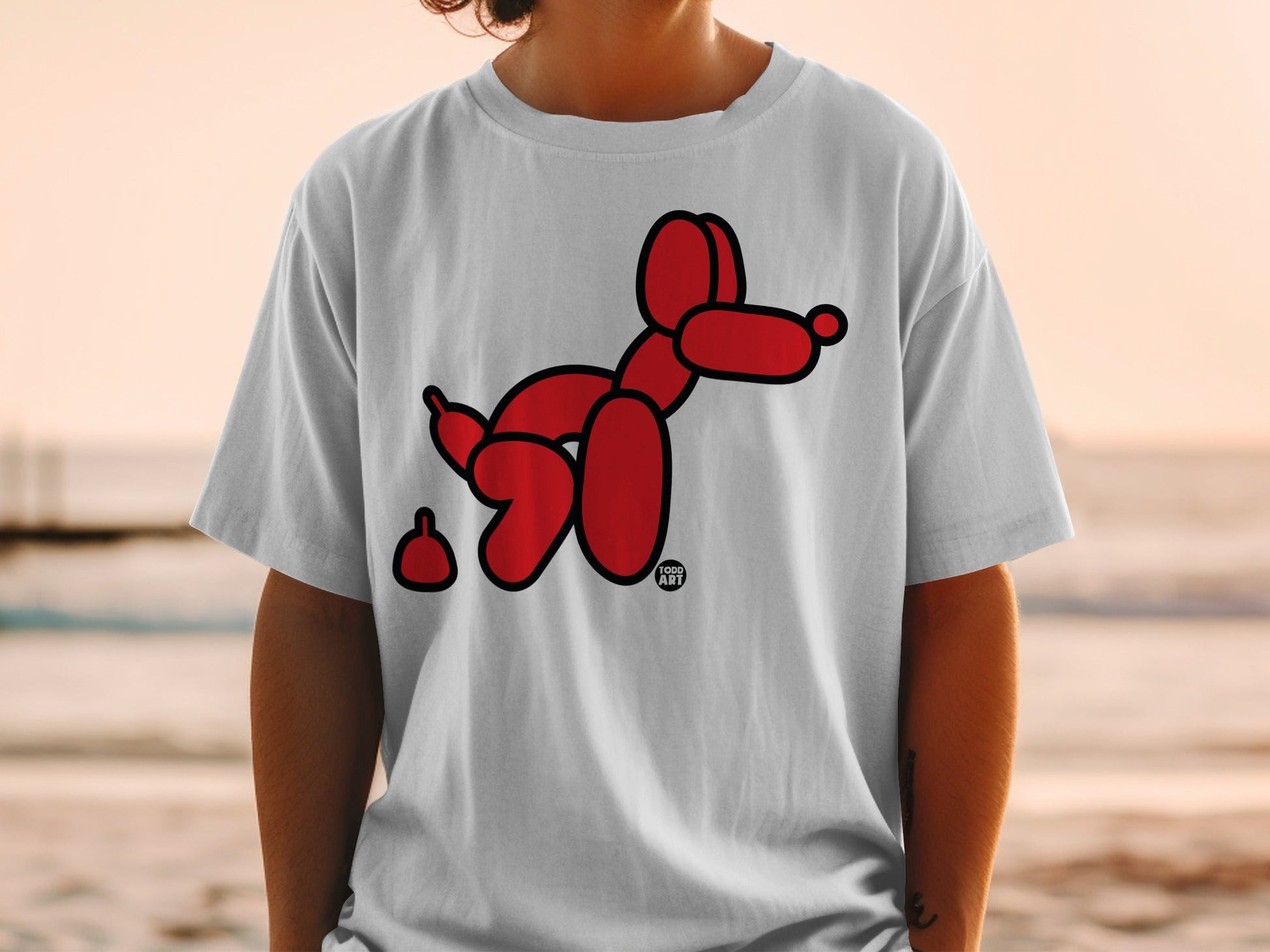 Red balloon dog with art logo on a white t-shirt.