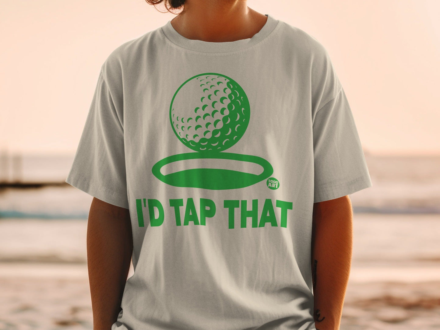 Light gray t-shirt with a golf ball graphic and "I'd Tap That" text.