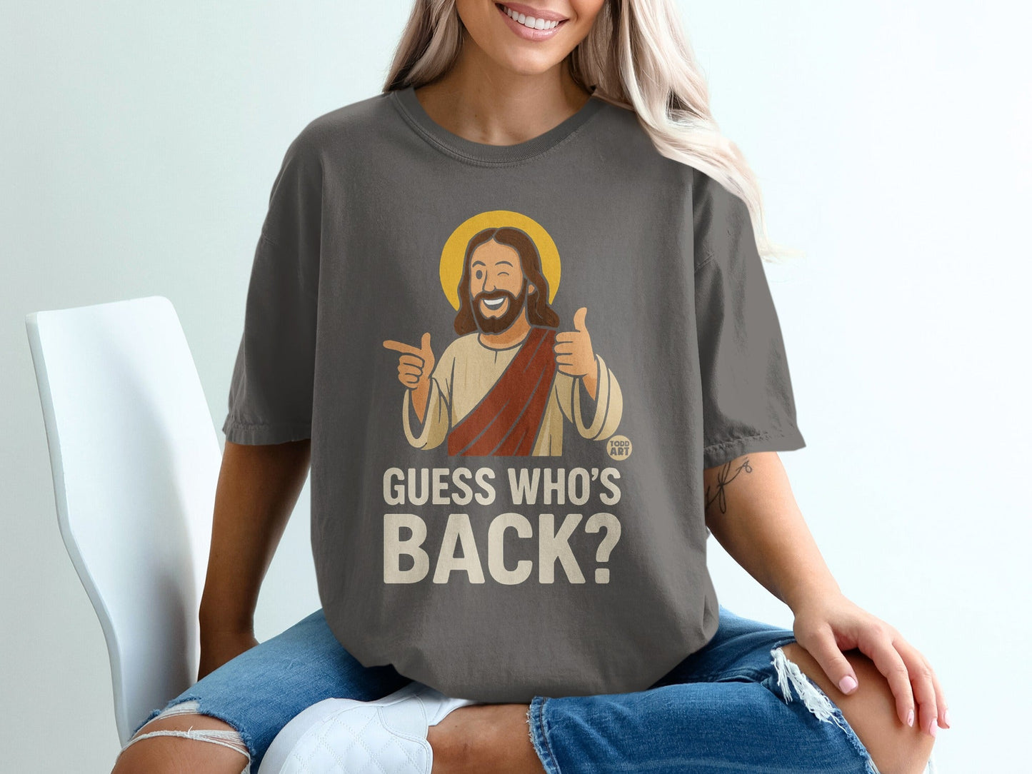 Dark gray t-shirt with Jesus giving a thumbs up and saying "Guess Who's Back?".