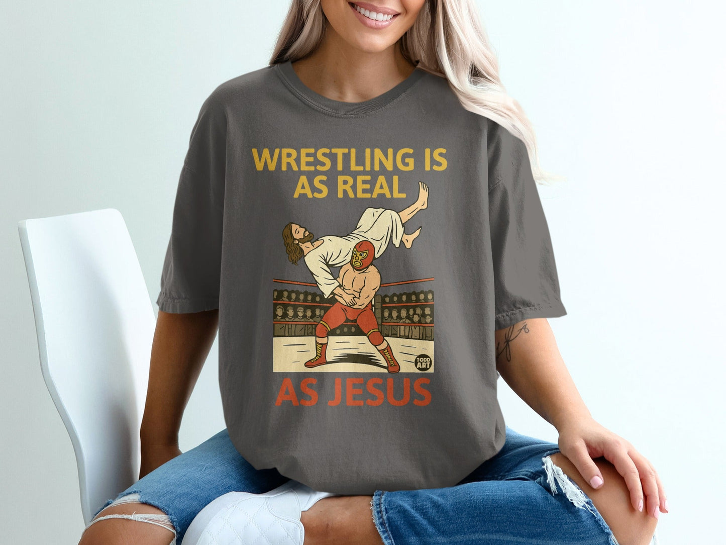 Jesus lifts a wrestler in a wrestling ring, text reads "Wrestling is Real, As Jesus".