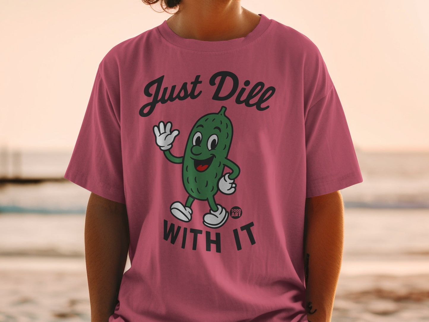 T-shirt with cartoon dill pickle saying "Just Dill With It."
