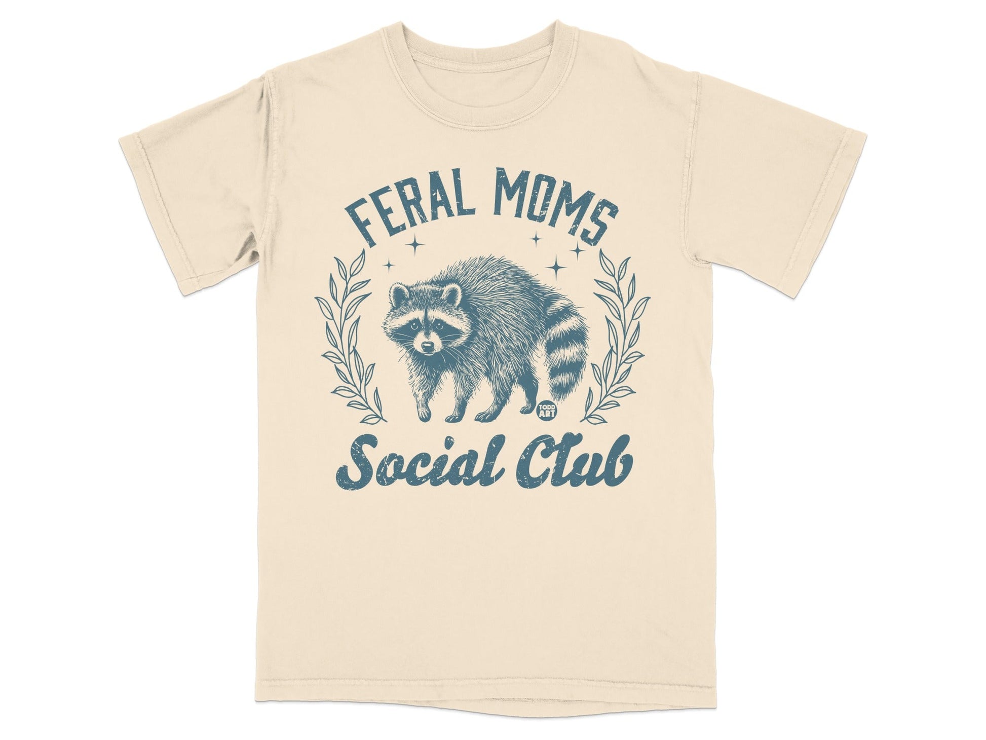 Cream t-shirt with raccoon graphic and "Feral Moms Social Club" text.