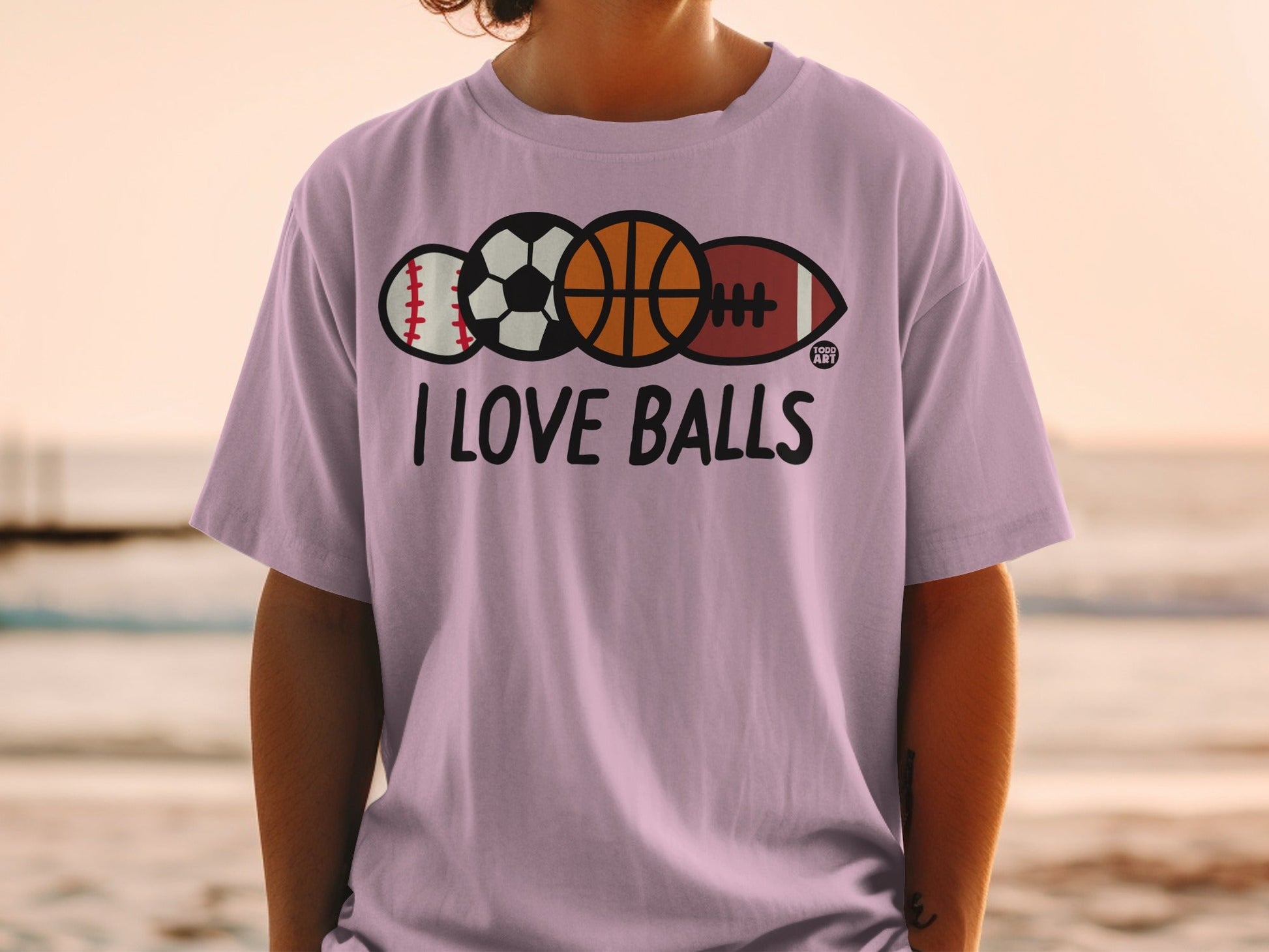 Purple t-shirt with "I LOVE BALLS" text and sports balls.