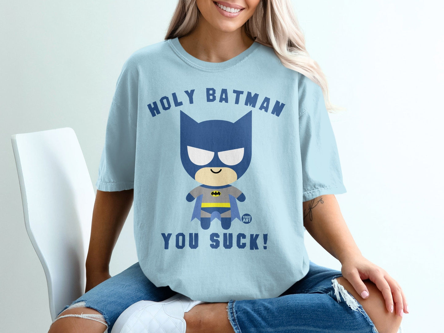Light blue t-shirt with "Holy Batman you suck!" text and cartoon Batman graphic.