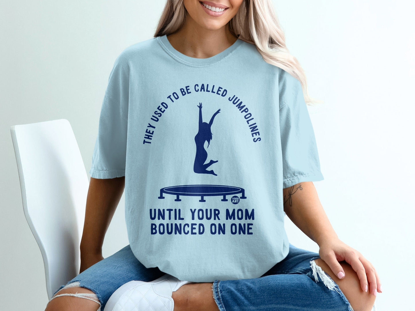 Light blue t-shirt with trampoline graphic and text: "They used to be called jumplines until your mom bounced on one."