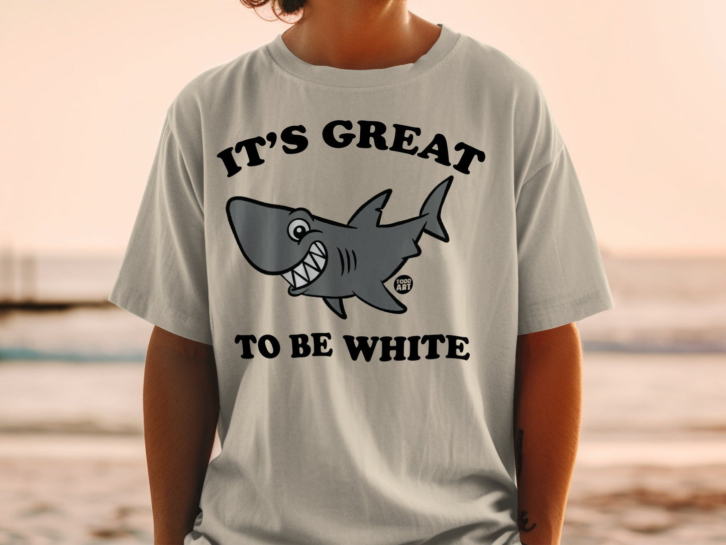 Light grey t-shirt with cartoon shark and text "IT'S GREAT TO BE WHITE".