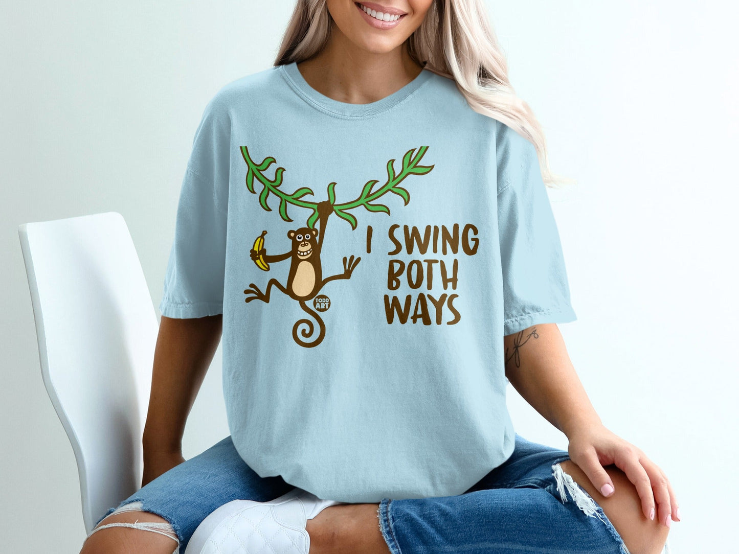 Light blue t-shirt with monkey swinging and text "I SWING BOTH WAYS".