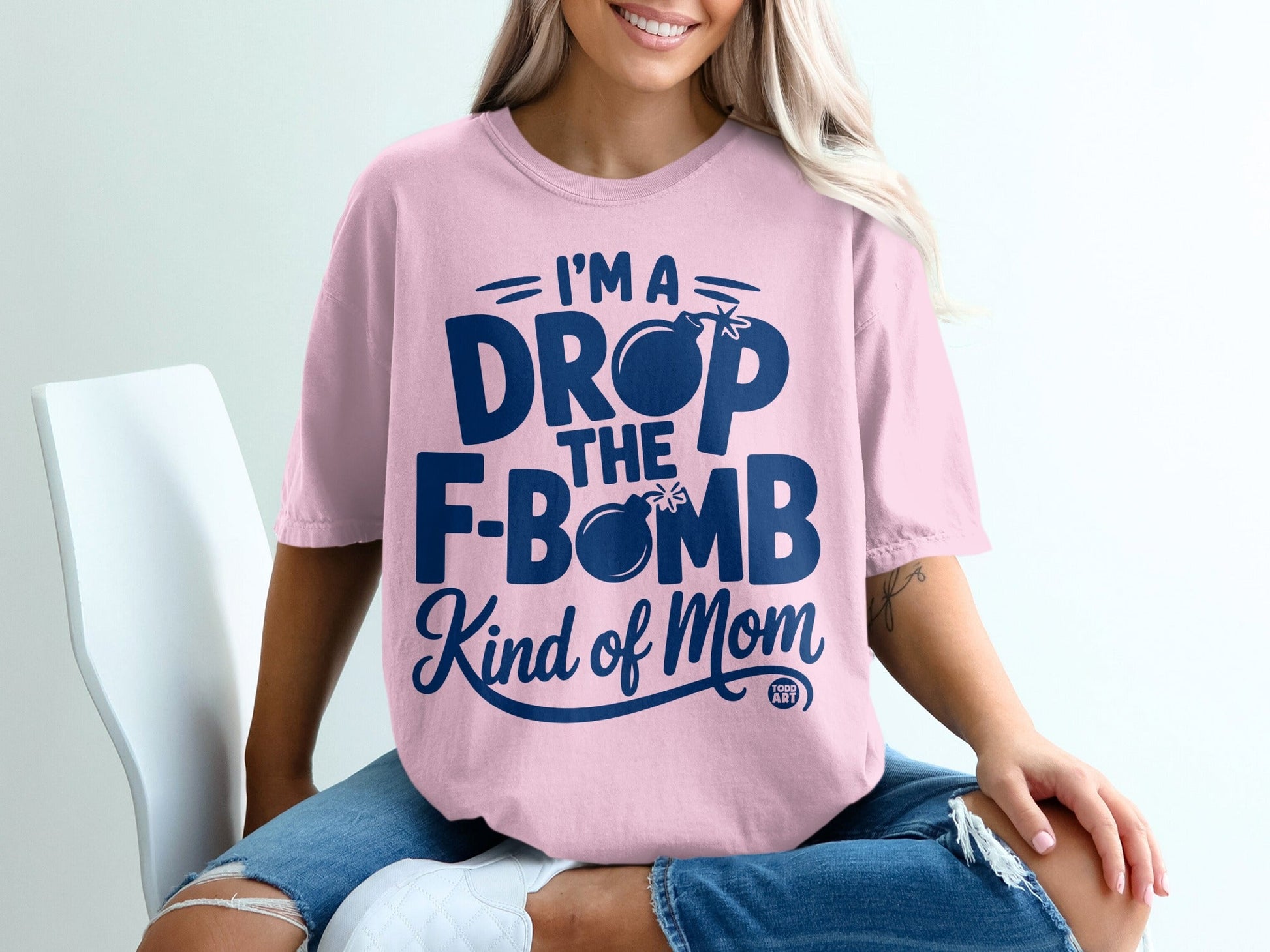Pink t-shirt with "I'm a drop the f-bomb kind of mom" text and bomb graphic.