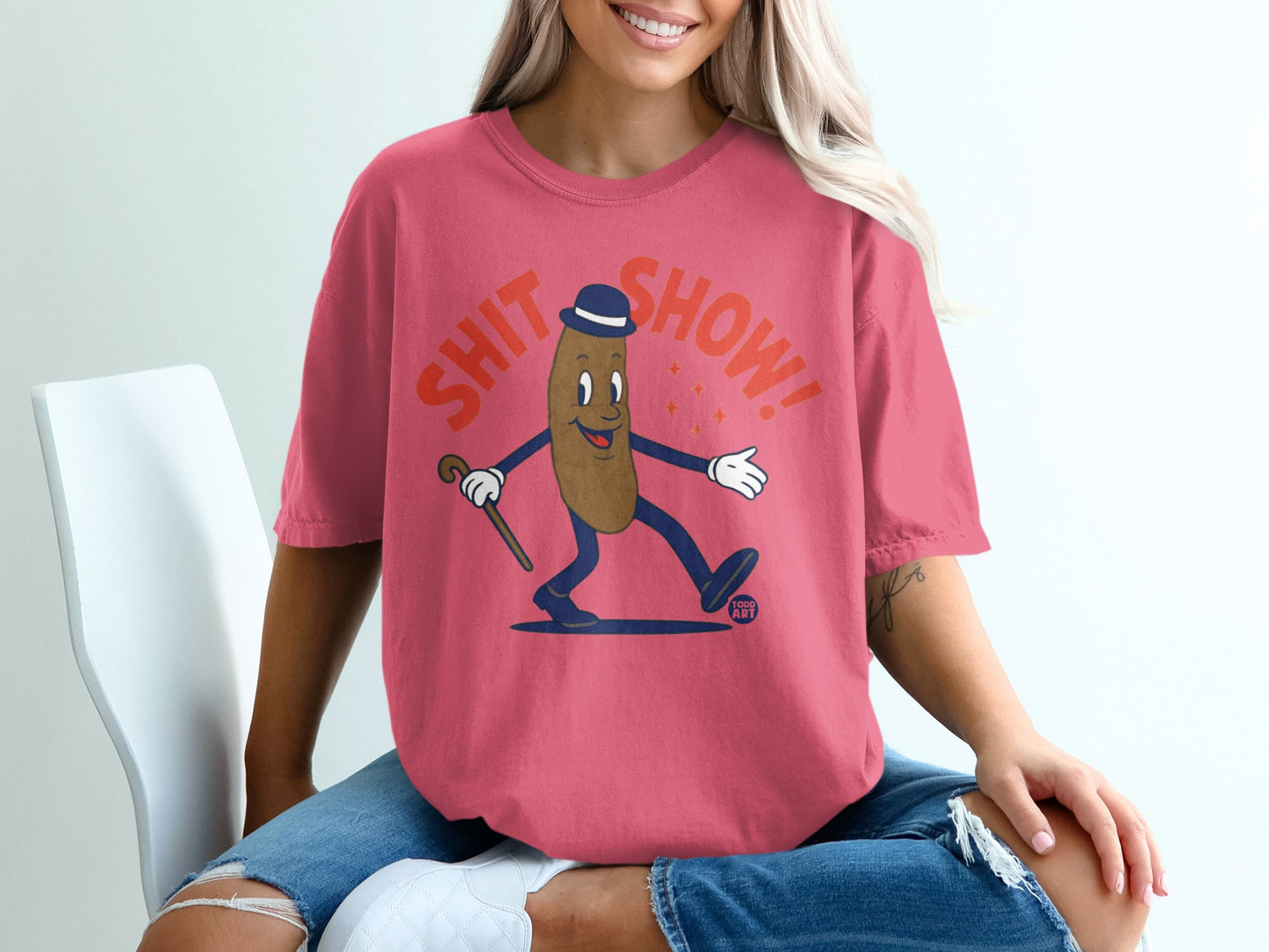 Brown cartoon character in a hat and bowtie with a cane, saying "Shit Show!"