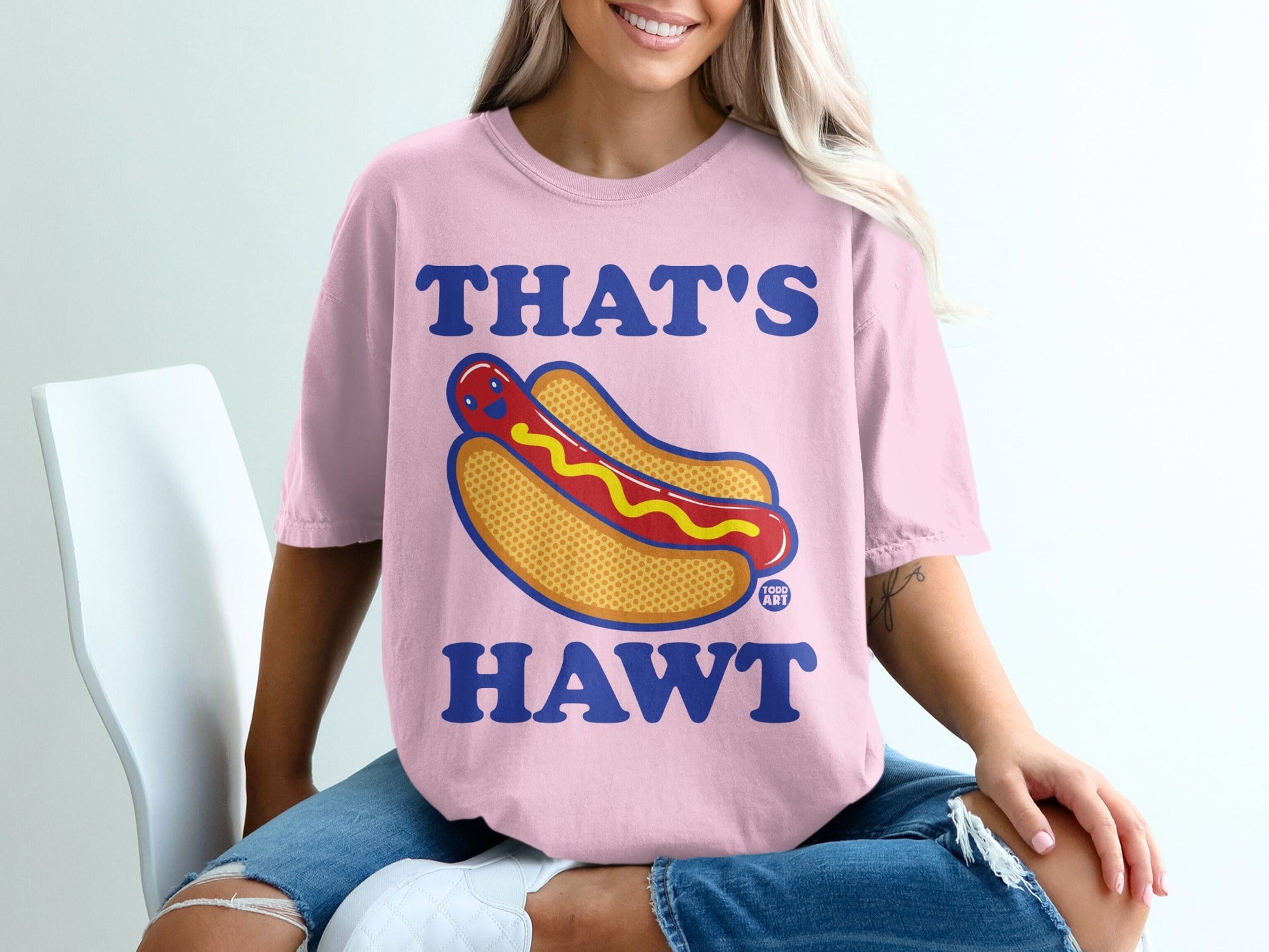 Pink t-shirt with "THAT'S HAWT" and a cartoon hot dog graphic.