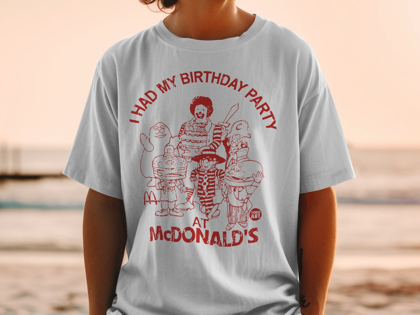 McDonald's birthday party graphic tee with cartoon characters and text.