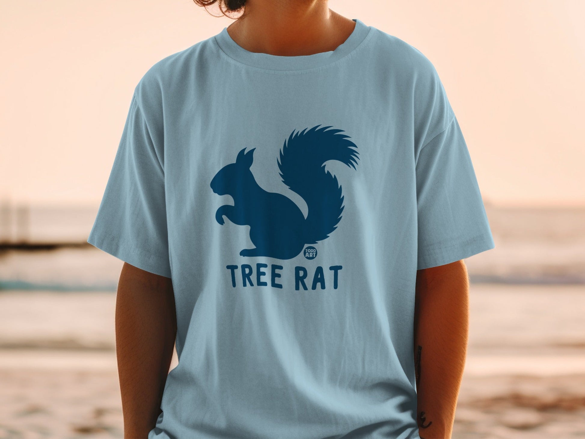 Light blue t-shirt with dark blue squirrel and "TREE RAT" logo.