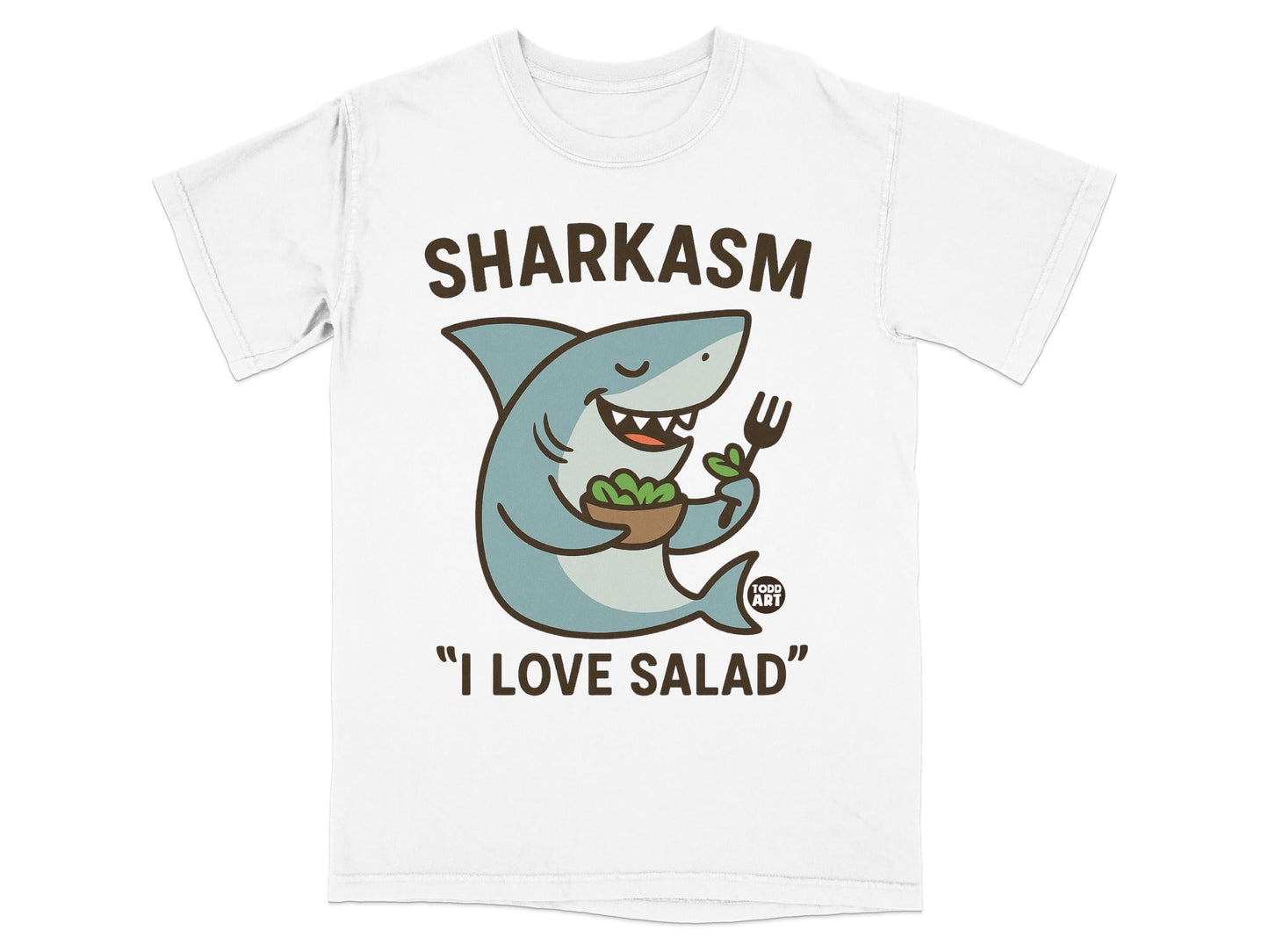 White t-shirt with cartoon shark holding salad and fork, text "SHARKASM" and "I LOVE SALAD".