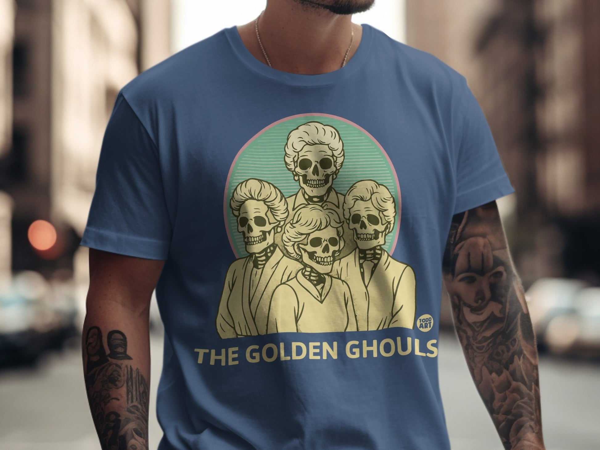 The Golden Ghouls t-shirt design features four stylized skeleton heads.