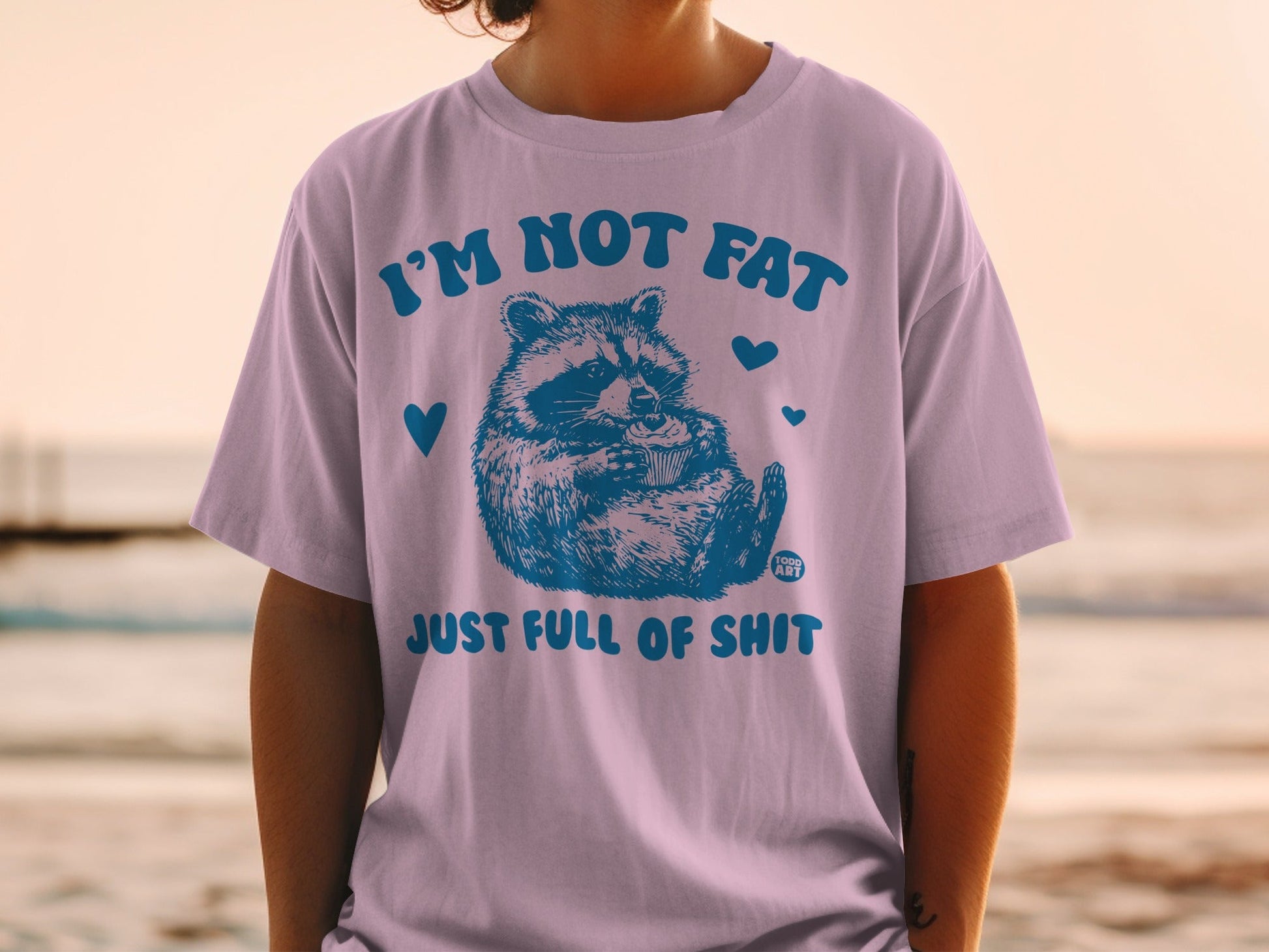 T-shirt with raccoon and text "I'm not fat just full of shit".