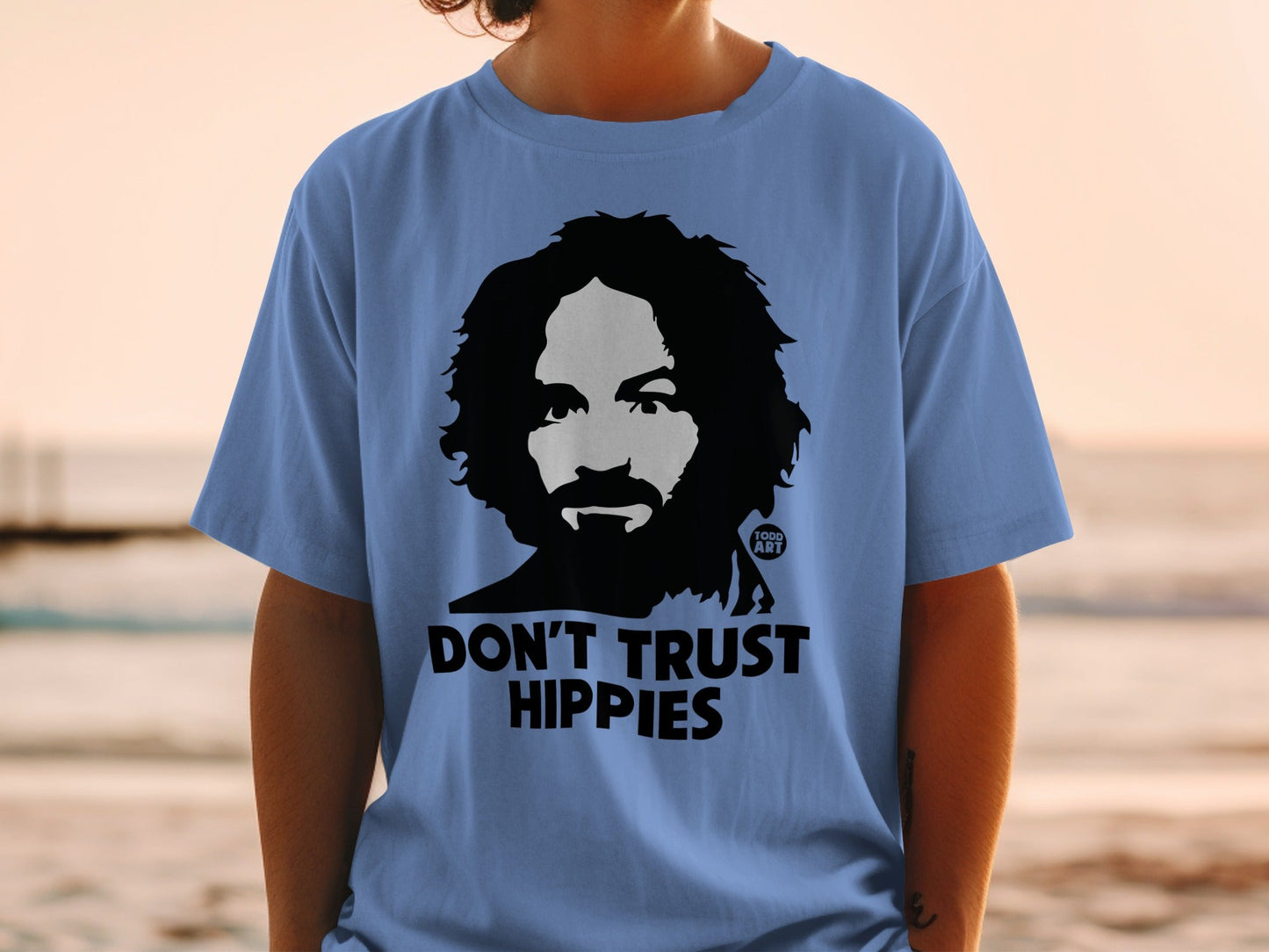 Light blue t-shirt with "DON'T TRUST HIPPIES" and a portrait.