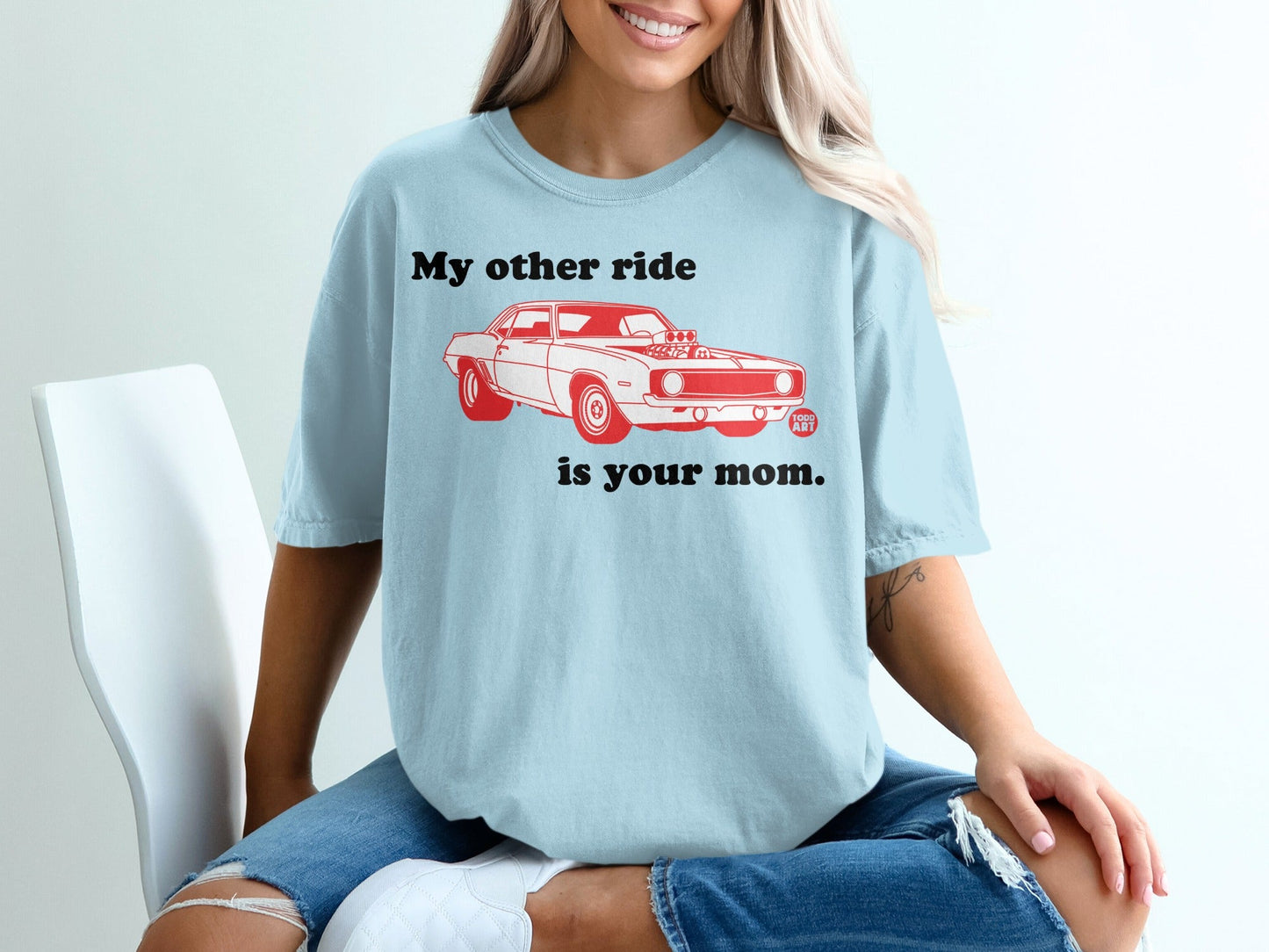 Light blue t-shirt with graphic of a red muscle car and text "My other ride is your mom."