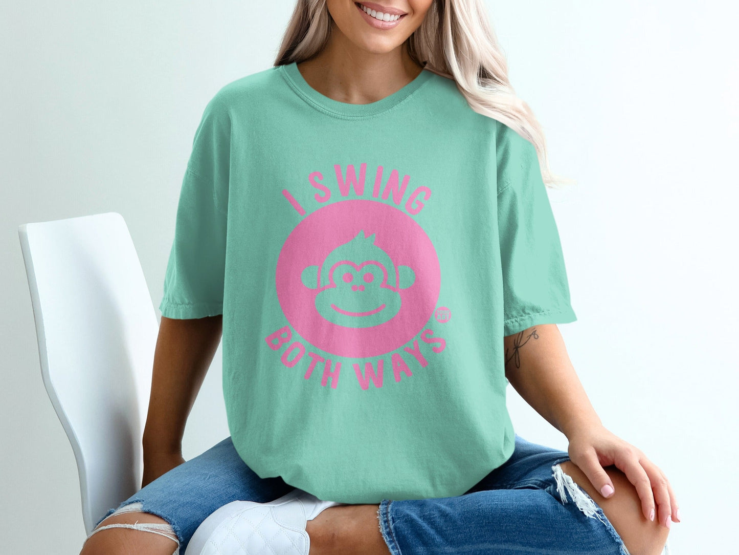 Mint green t-shirt with pink text "I swing both ways" and monkey graphic.