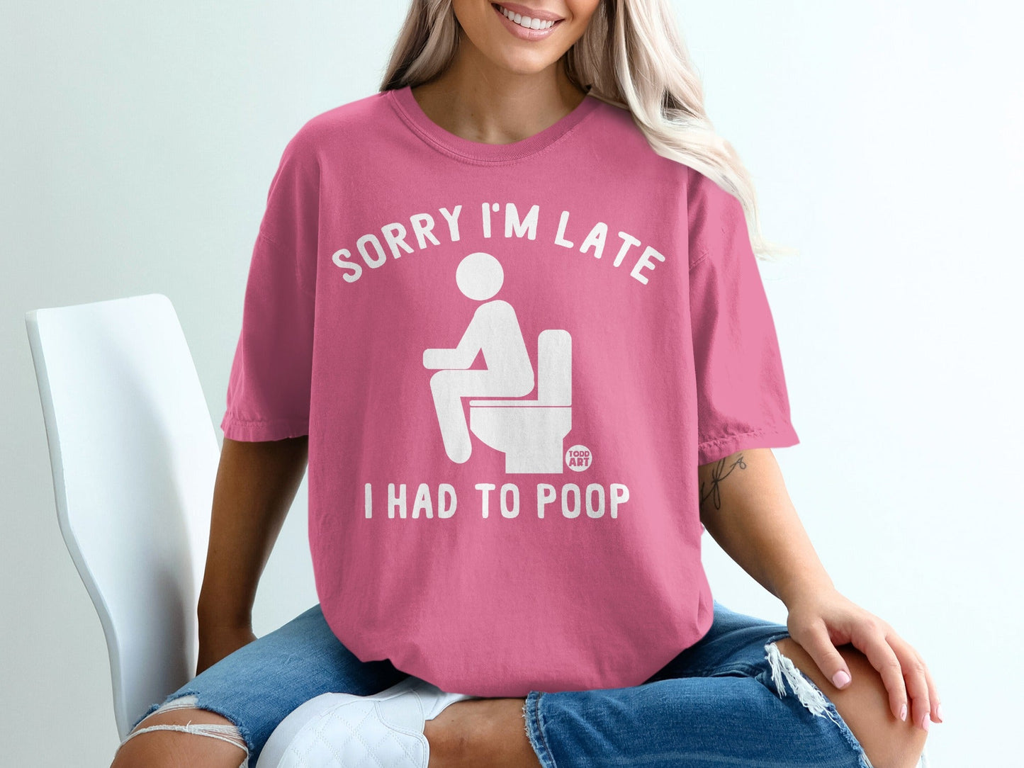 Pink t-shirt with "SORRY I'M LATE I HAD TO POOP" text and toilet graphic.