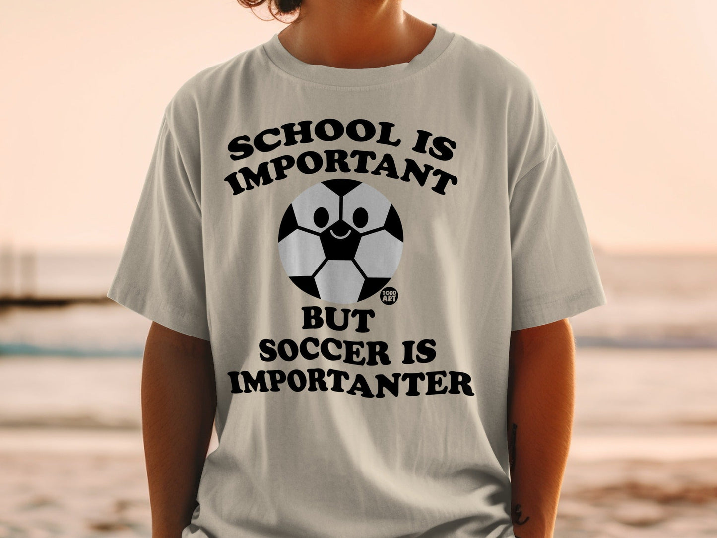 T-shirt with soccer ball graphic and "SCHOOL IS IMPORTANT BUT SOCCER IS IMPORTANTER" text.