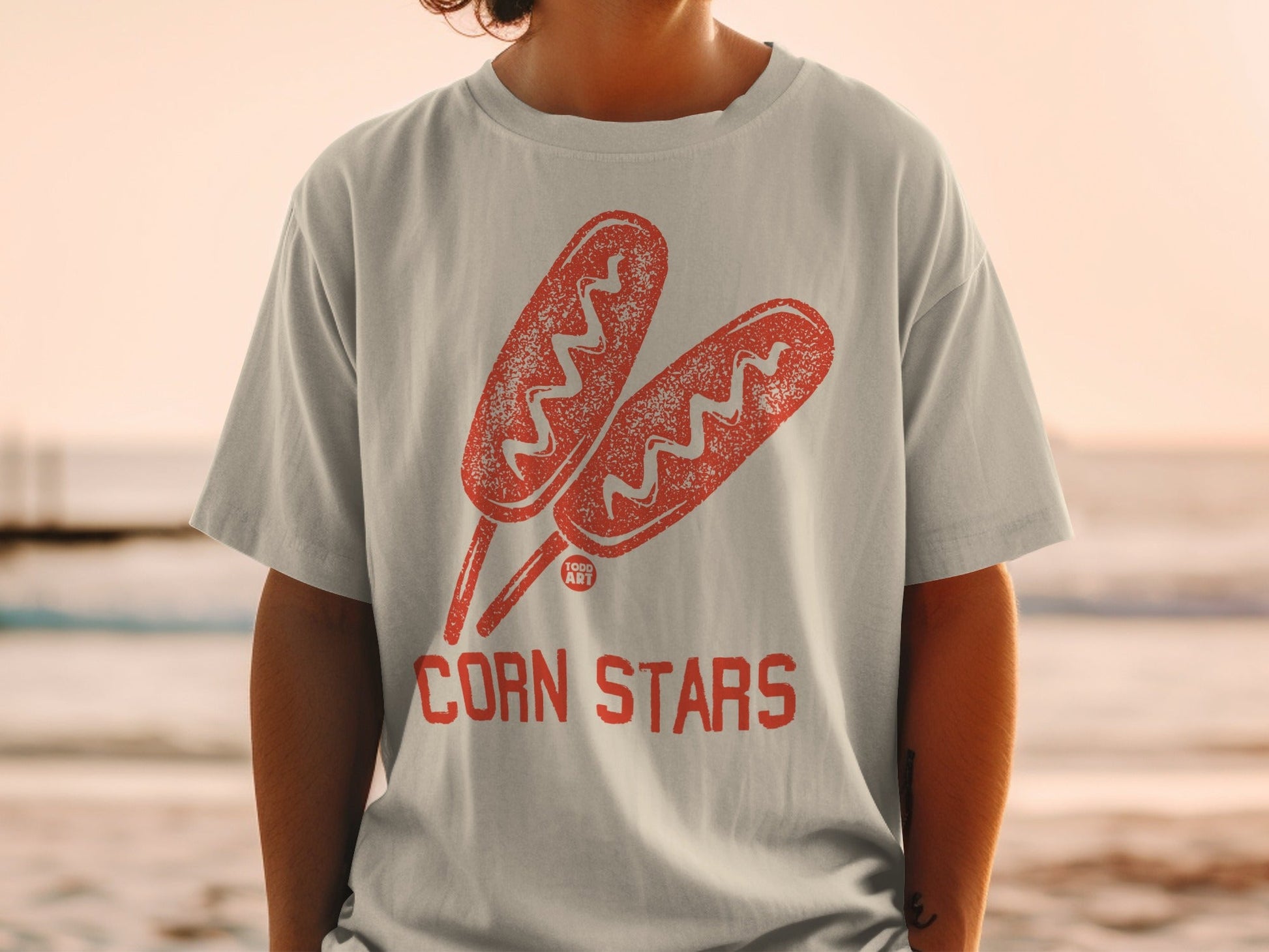 White t-shirt with red corn dog illustration and "CORN STARS" text.