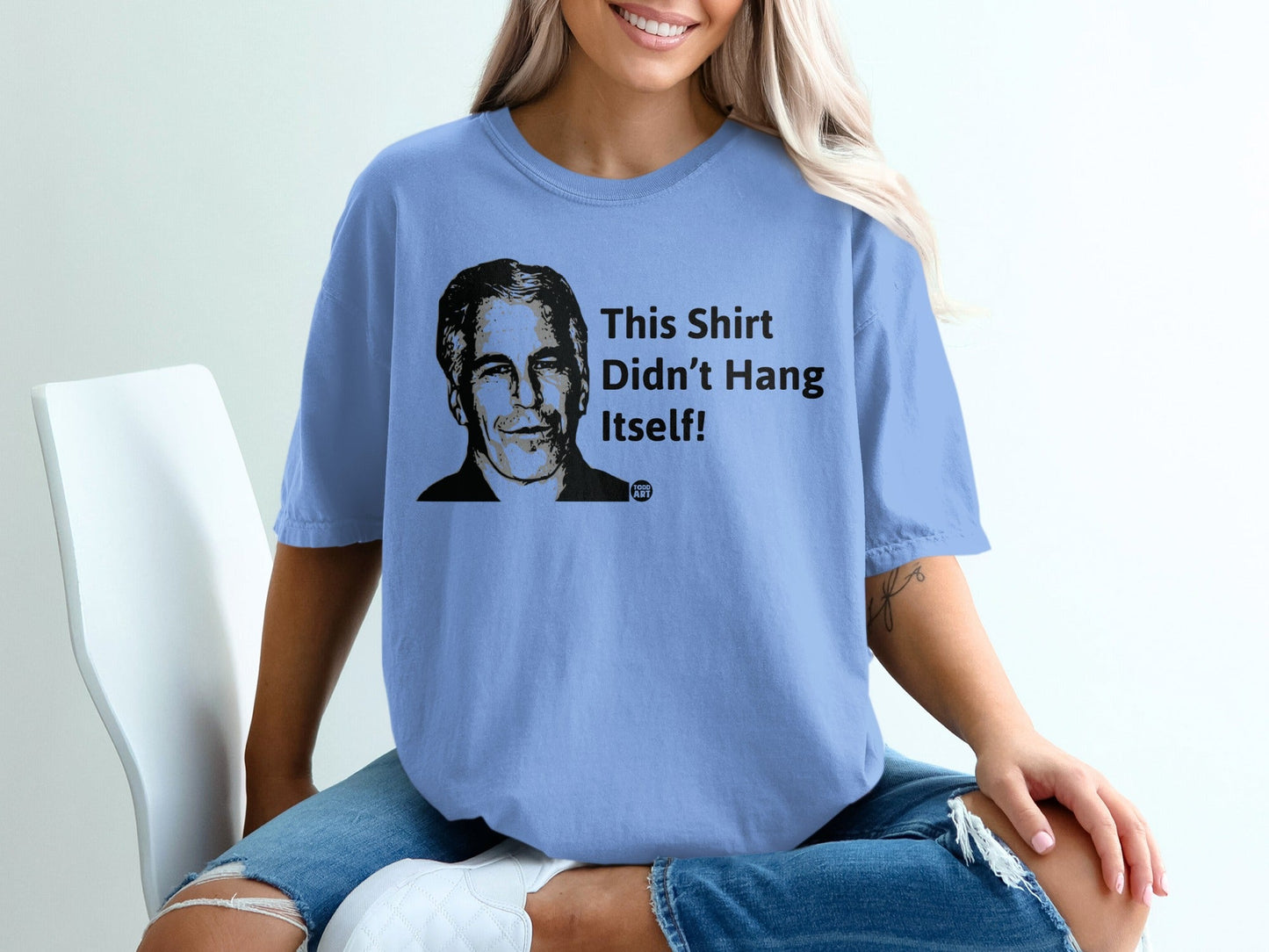 Blue t-shirt with a portrait and "This Shirt Didn't Hang Itself!" text.
