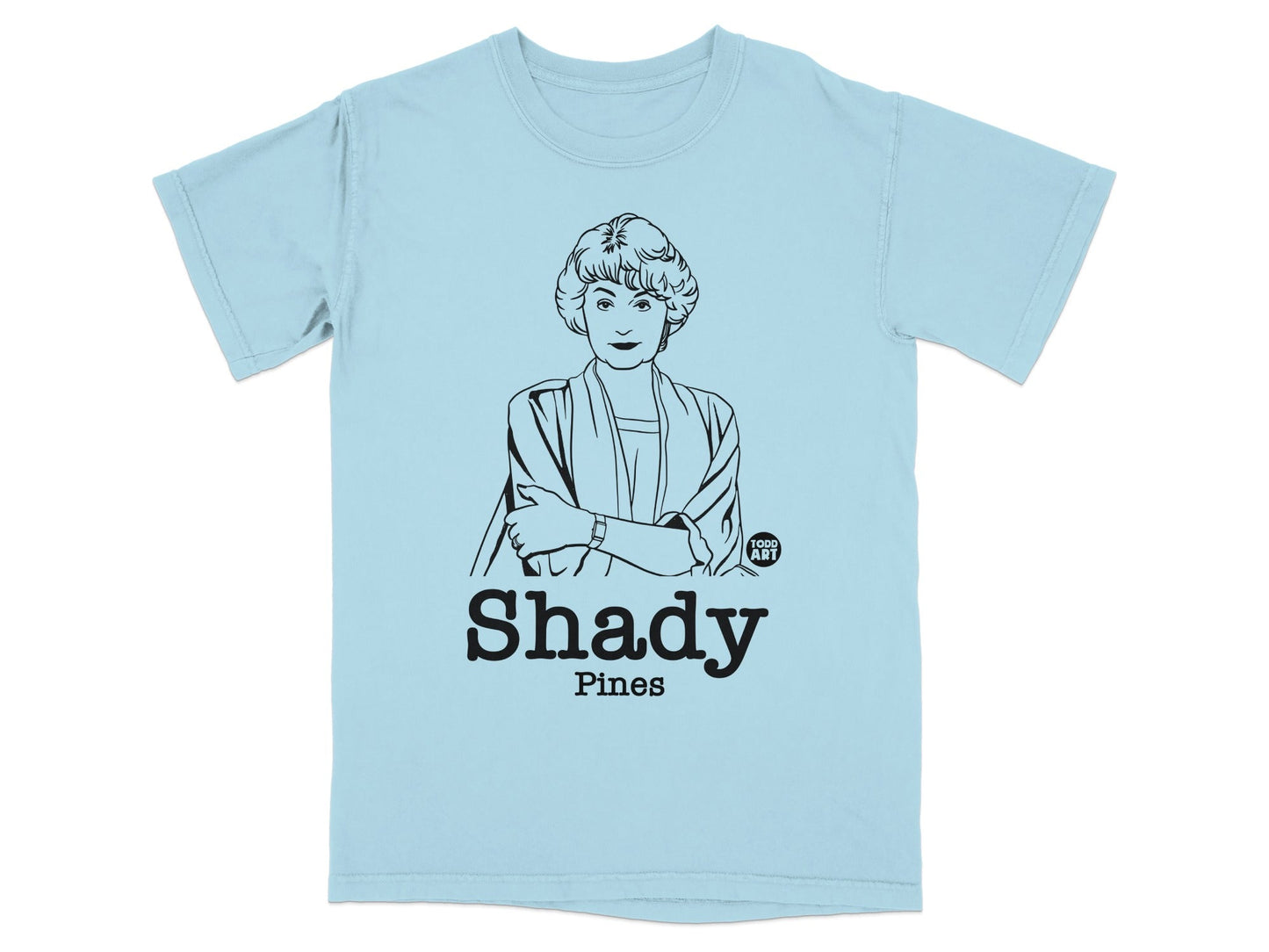 Light blue t-shirt with black line drawing of Blanche Devereaux and "Shady Pines" text.